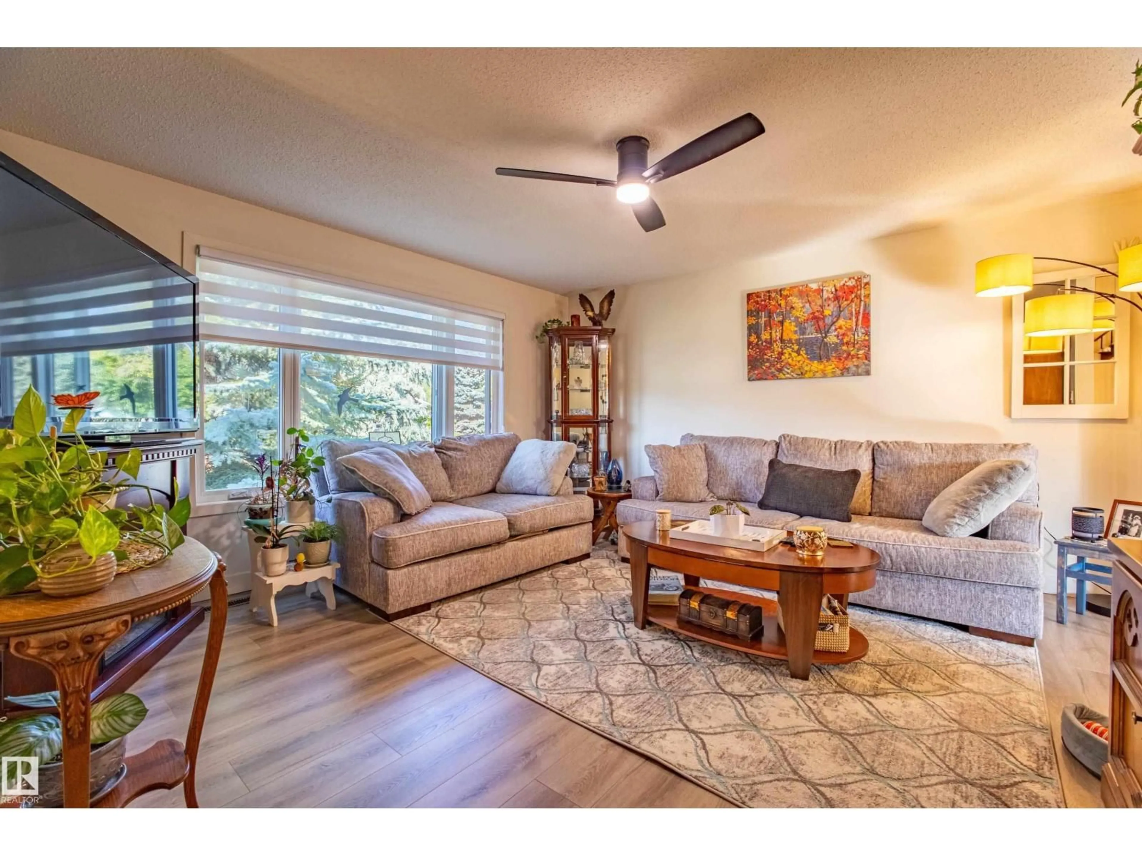 Living room with furniture, wood/laminate floor for 3143 73 ST, Edmonton Alberta T6K1K2