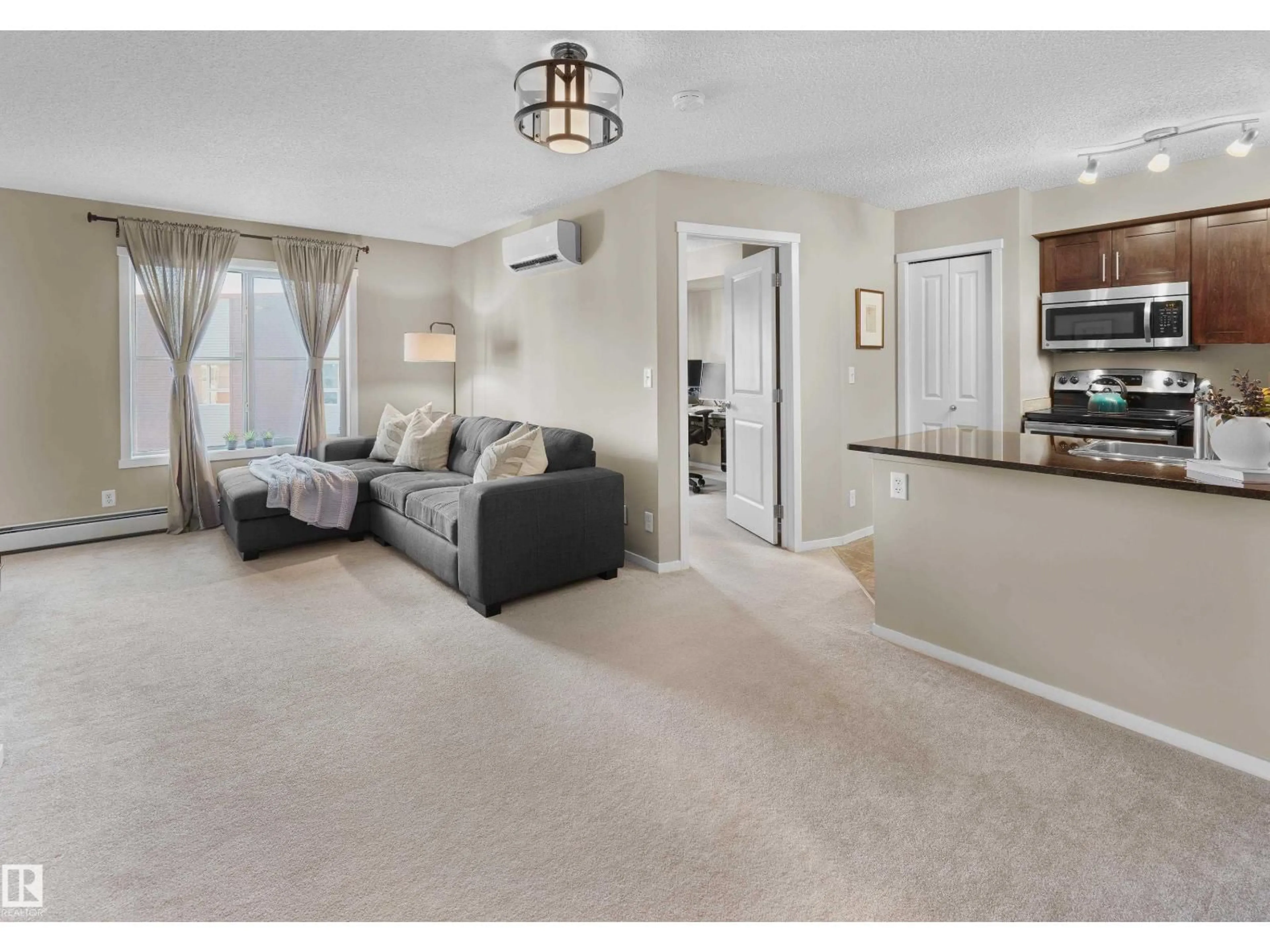 Living room with furniture, carpet floor for 407 - 5816 MULLEN PL, Edmonton Alberta T6R0W3