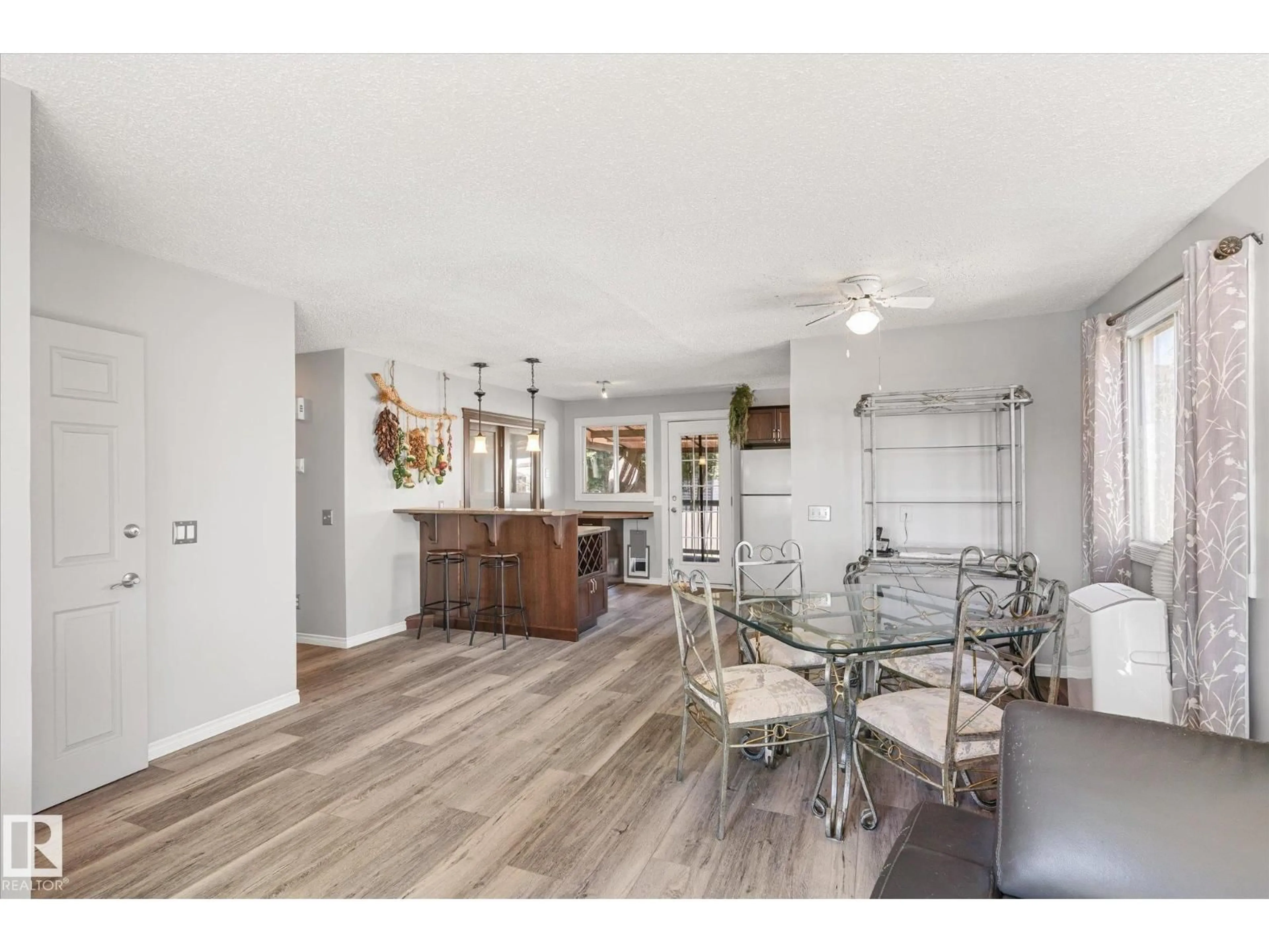Open concept kitchen, wood/laminate floor for NW - 3012 35 ST, Edmonton Alberta T6L4N4