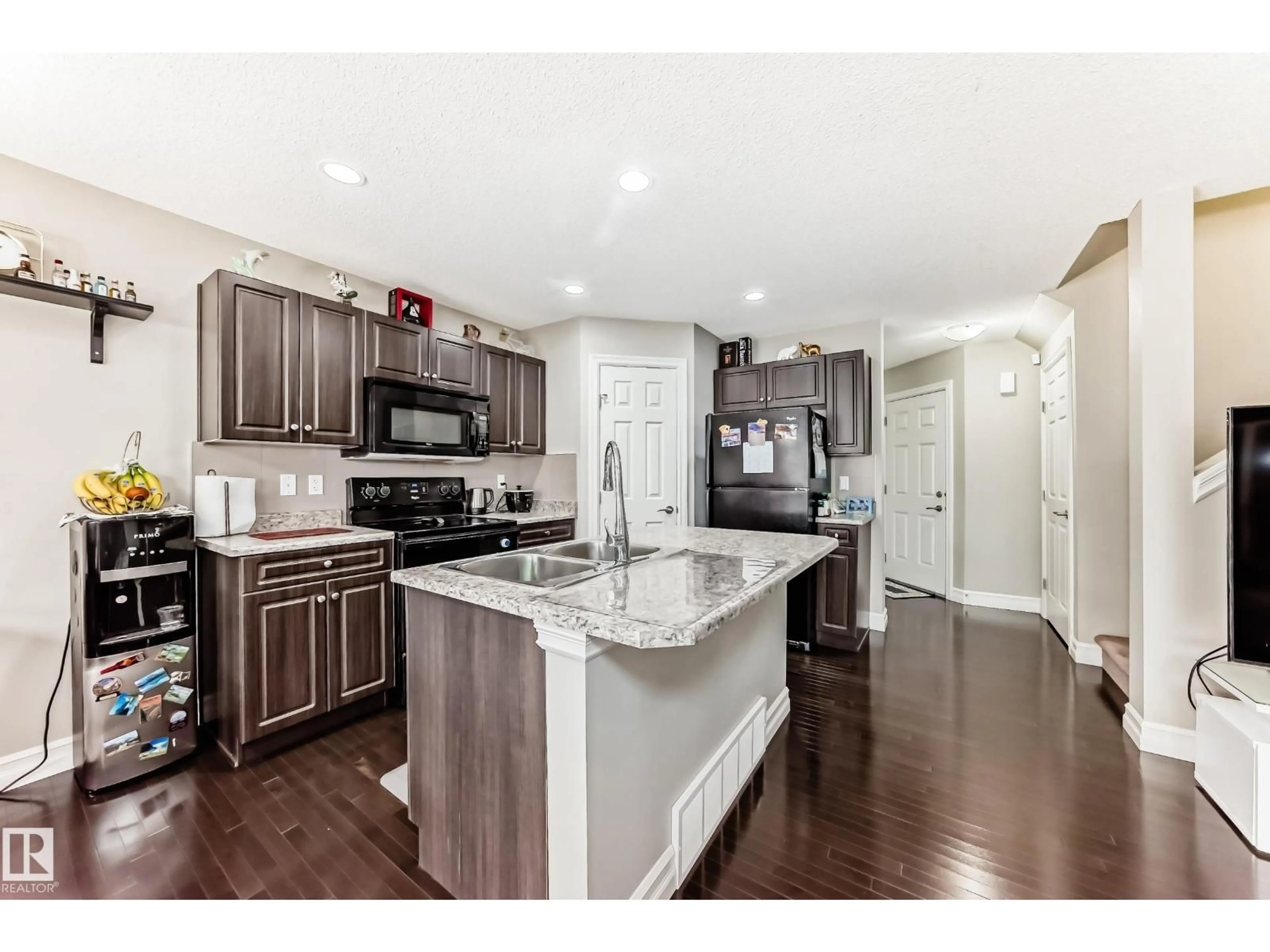 Open concept kitchen, wood/laminate floor for NW - 16506 135 ST, Edmonton Alberta T6V0G7