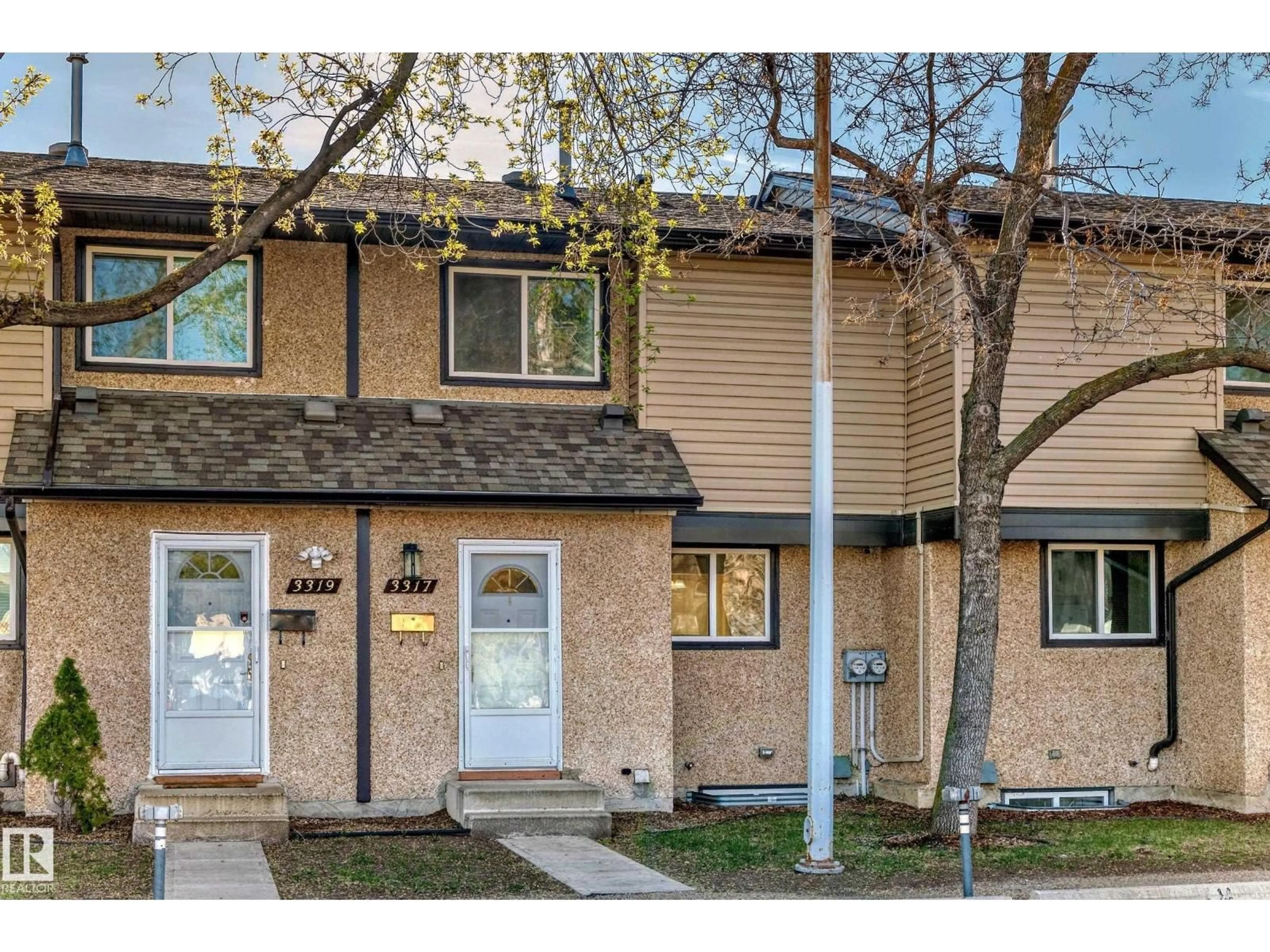 Home with vinyl exterior material, street for 3317 142 AV, Edmonton Alberta T5Y1H9