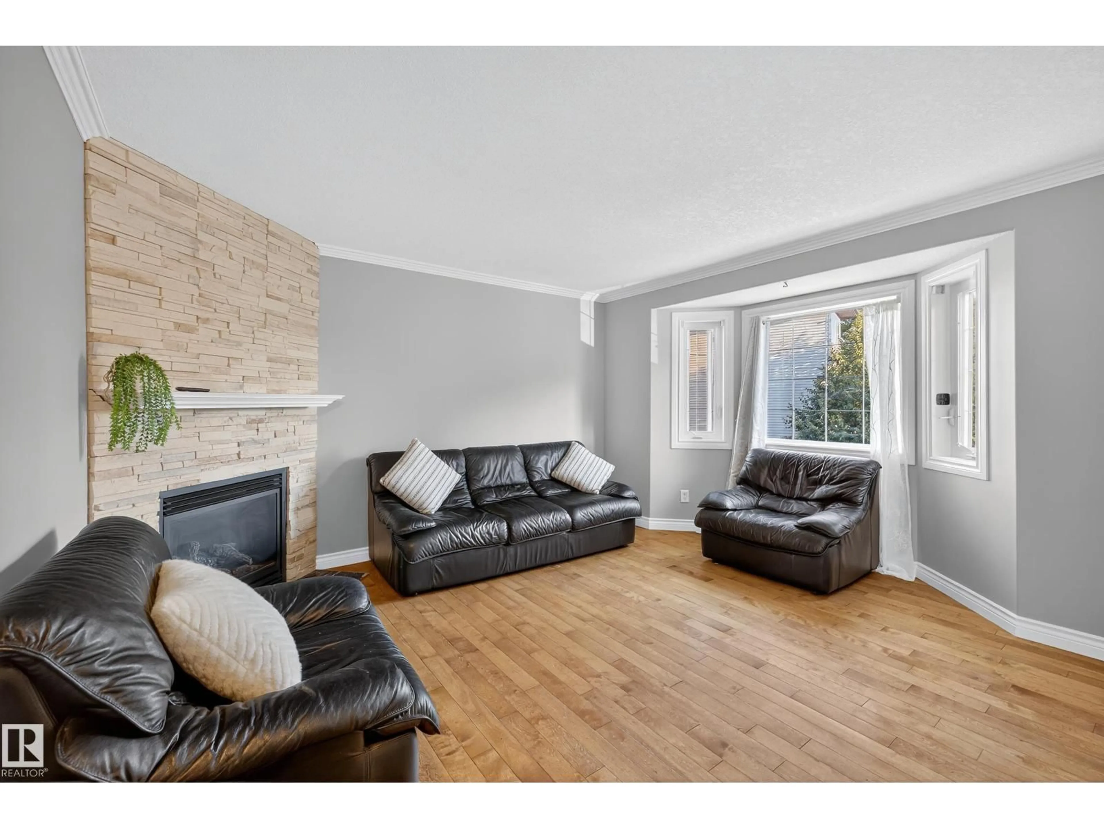 Living room with furniture, wood/laminate floor for 10 - 17839 99 ST NW, Edmonton Alberta T5X6A6