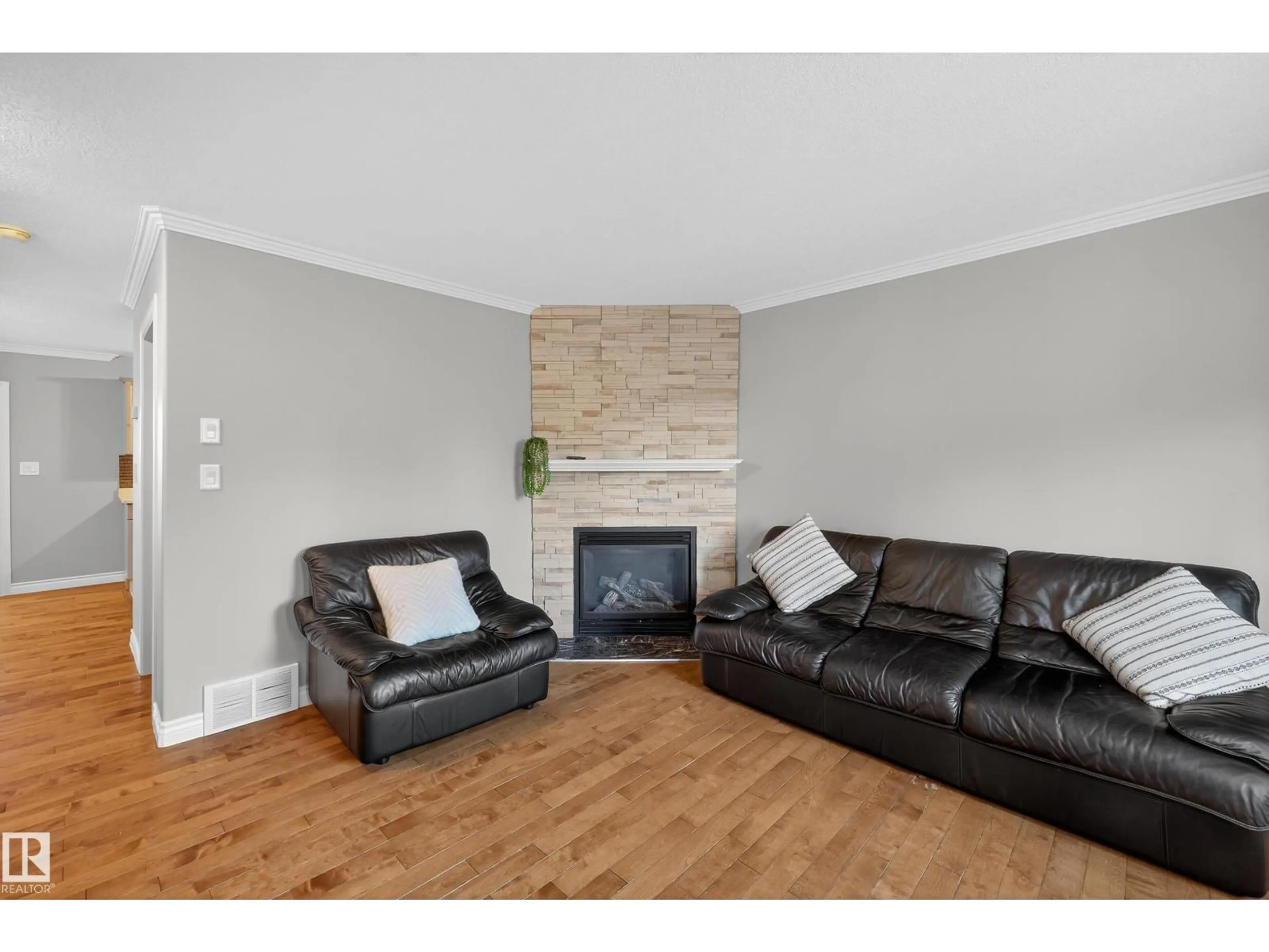 Living room with furniture, wood/laminate floor for 10 - 17839 99 ST NW, Edmonton Alberta T5X6A6