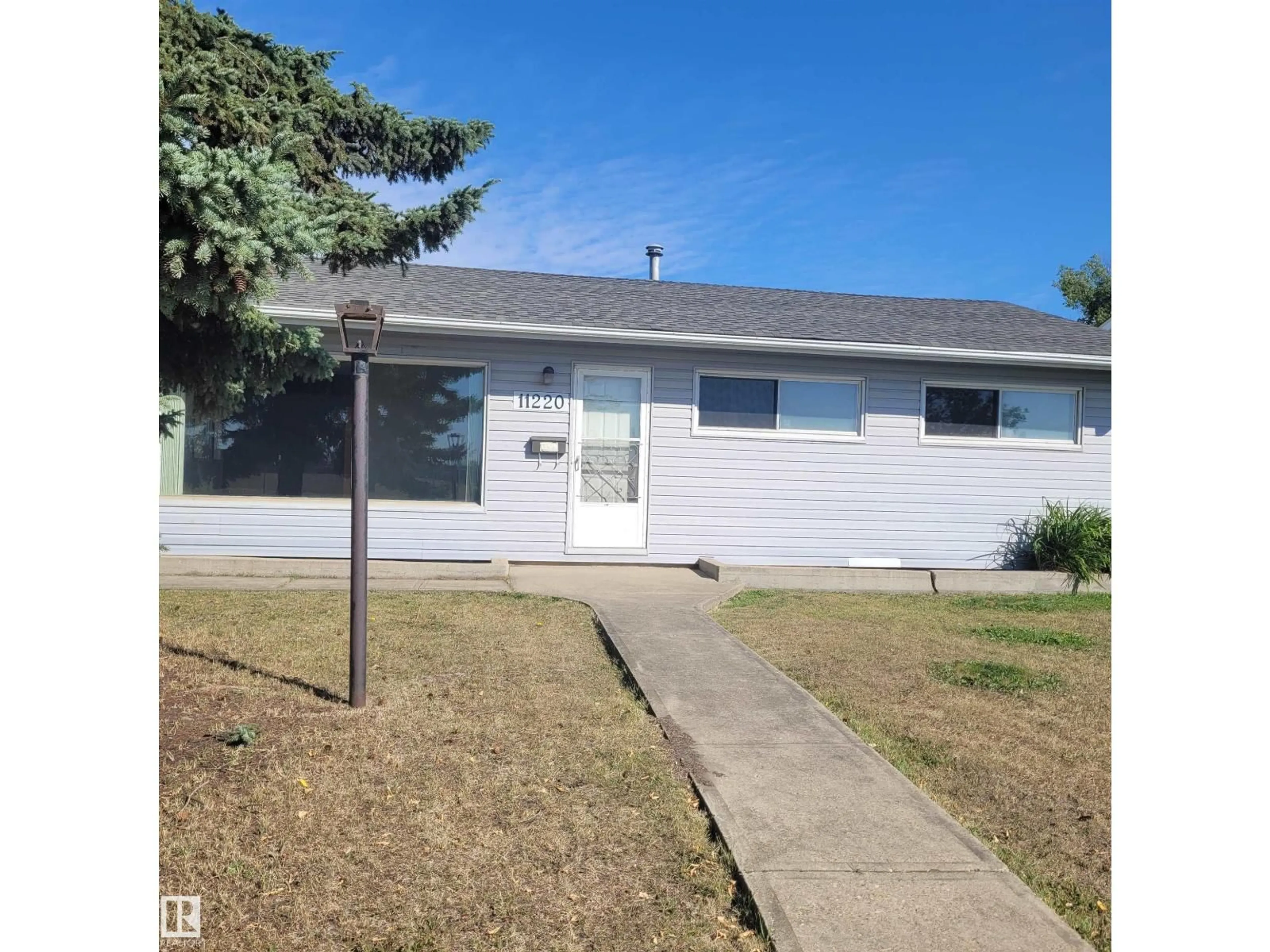 Home with vinyl exterior material, street for 11220 134 AV, Edmonton Alberta T5E1K5