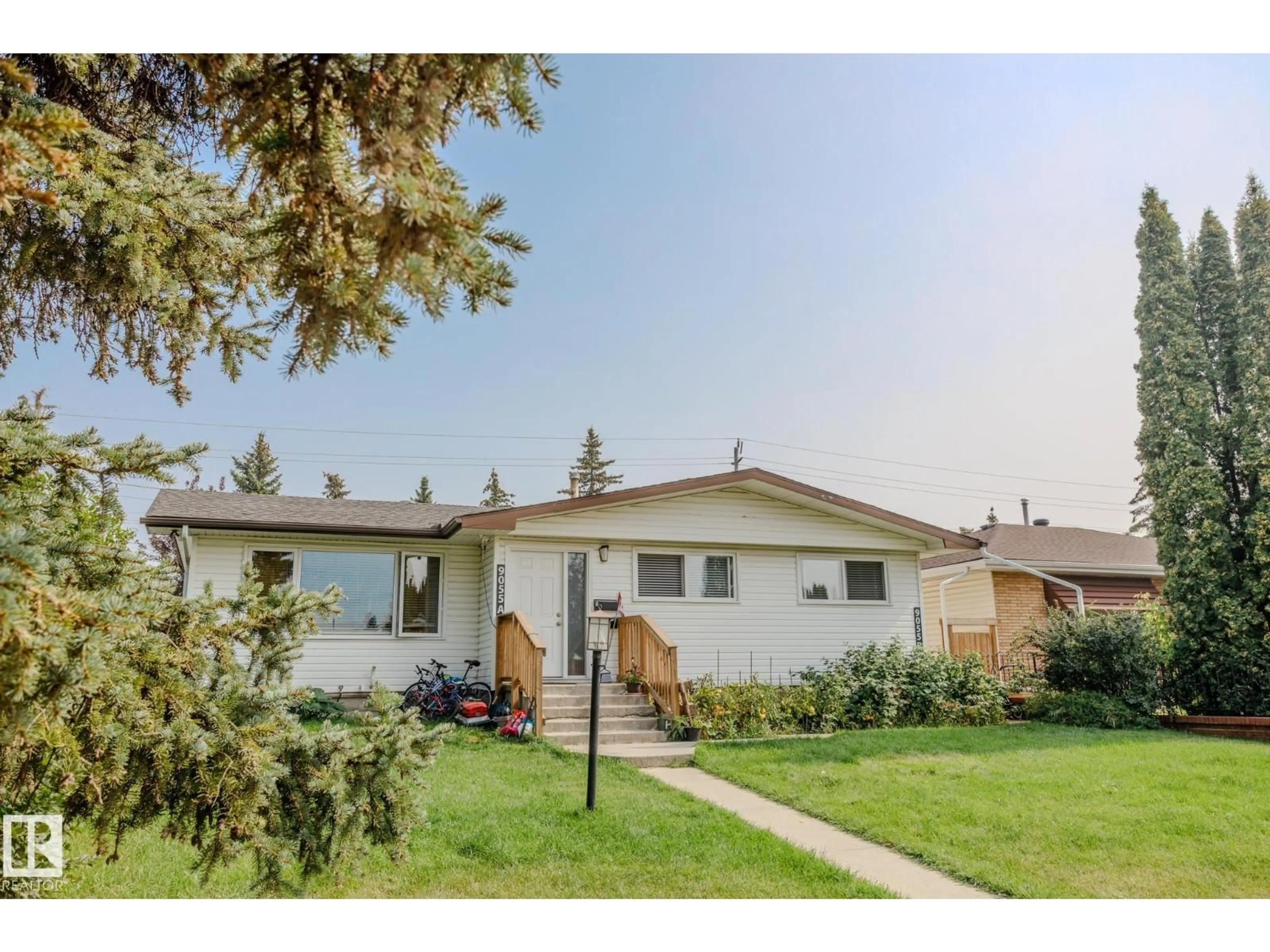 Home with vinyl exterior material, street for 9055 52 ST, Edmonton Alberta T6B1G1