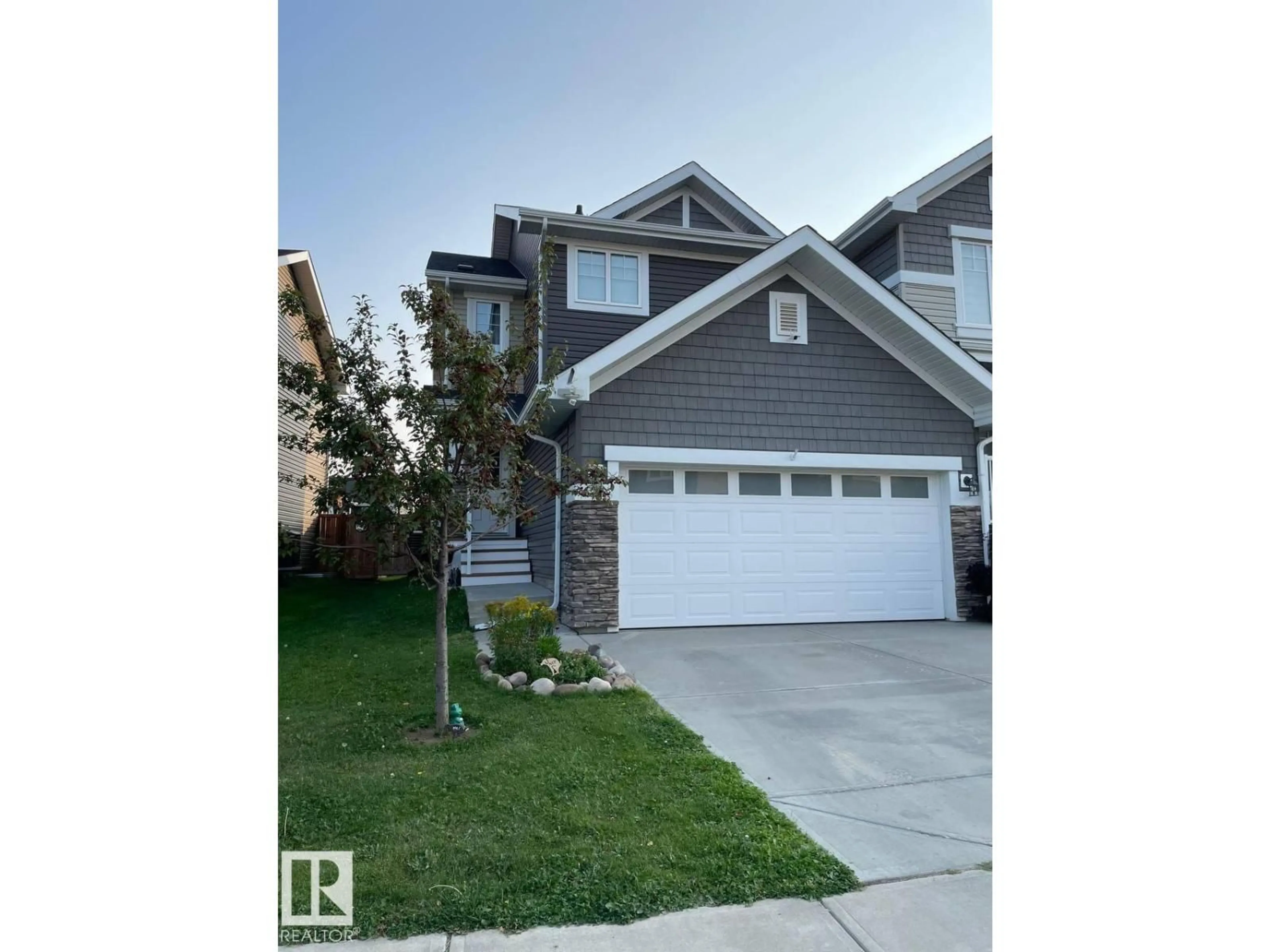 Home with vinyl exterior material, street for 6864 EVANS WD, Edmonton Alberta T6M0T6