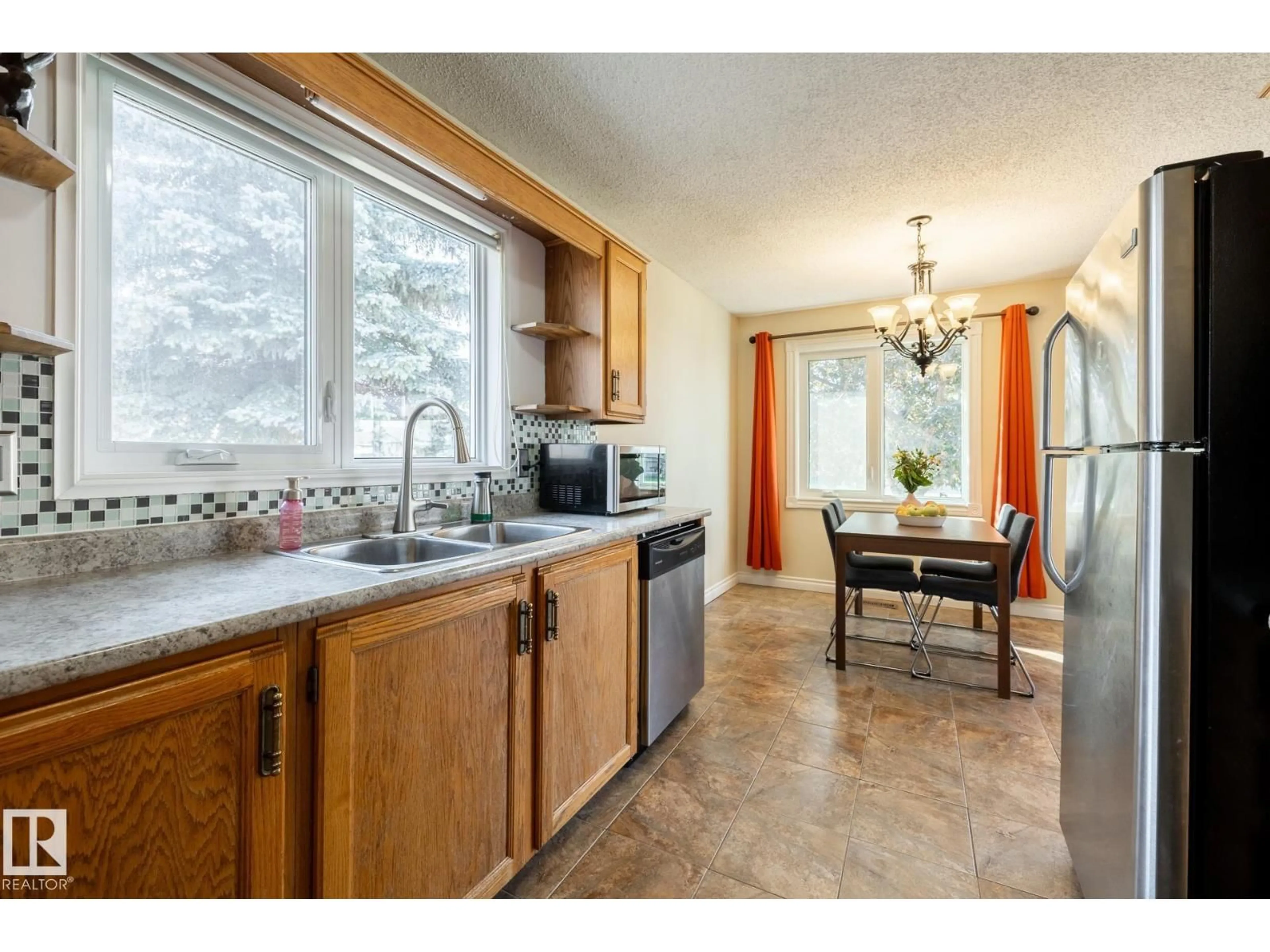 Open concept kitchen, ceramic/tile floor for 7272 152C AV, Edmonton Alberta T5C3N2