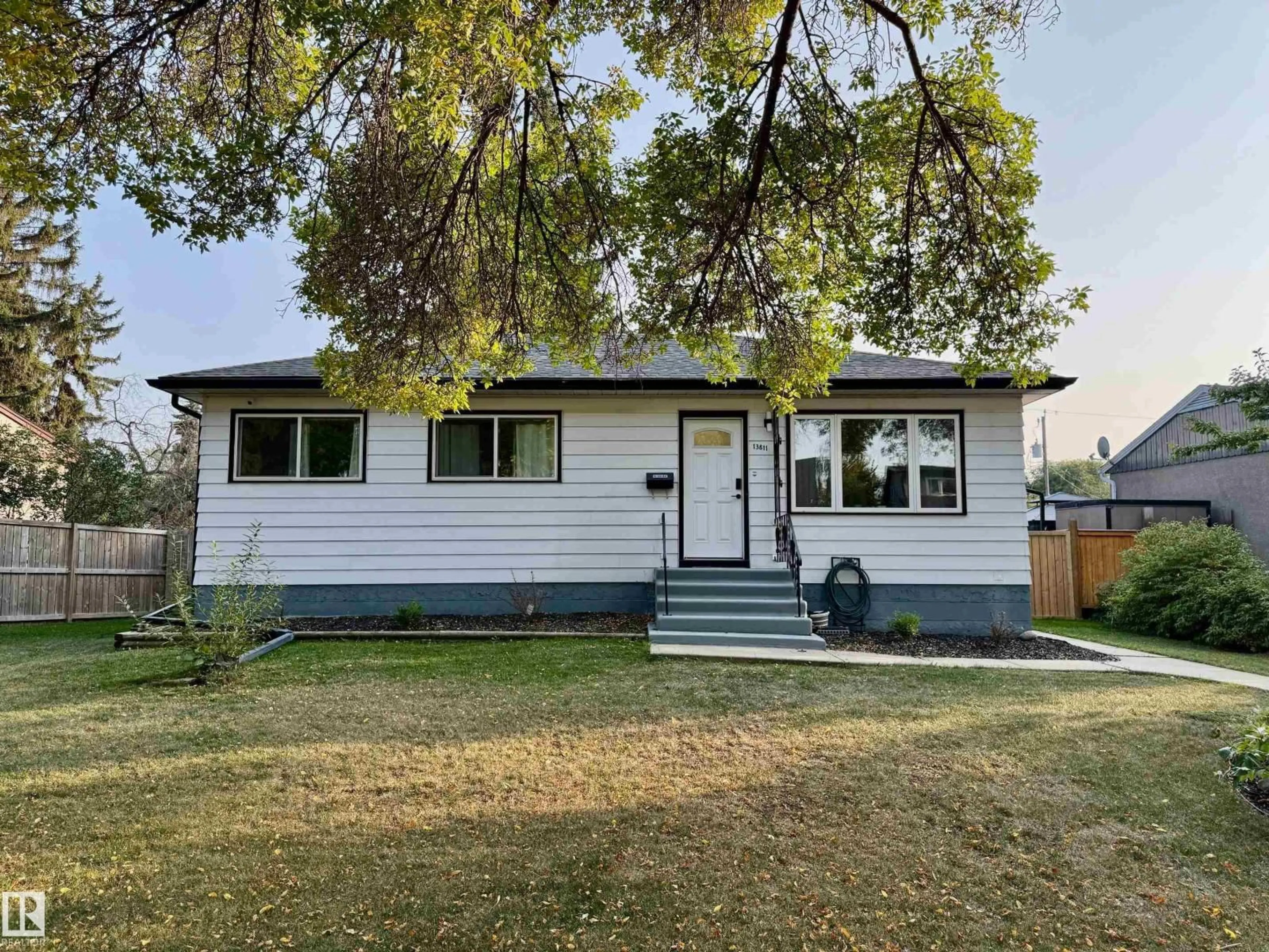 Home with vinyl exterior material, street for 13811 110A AV, Edmonton Alberta T5M2N1