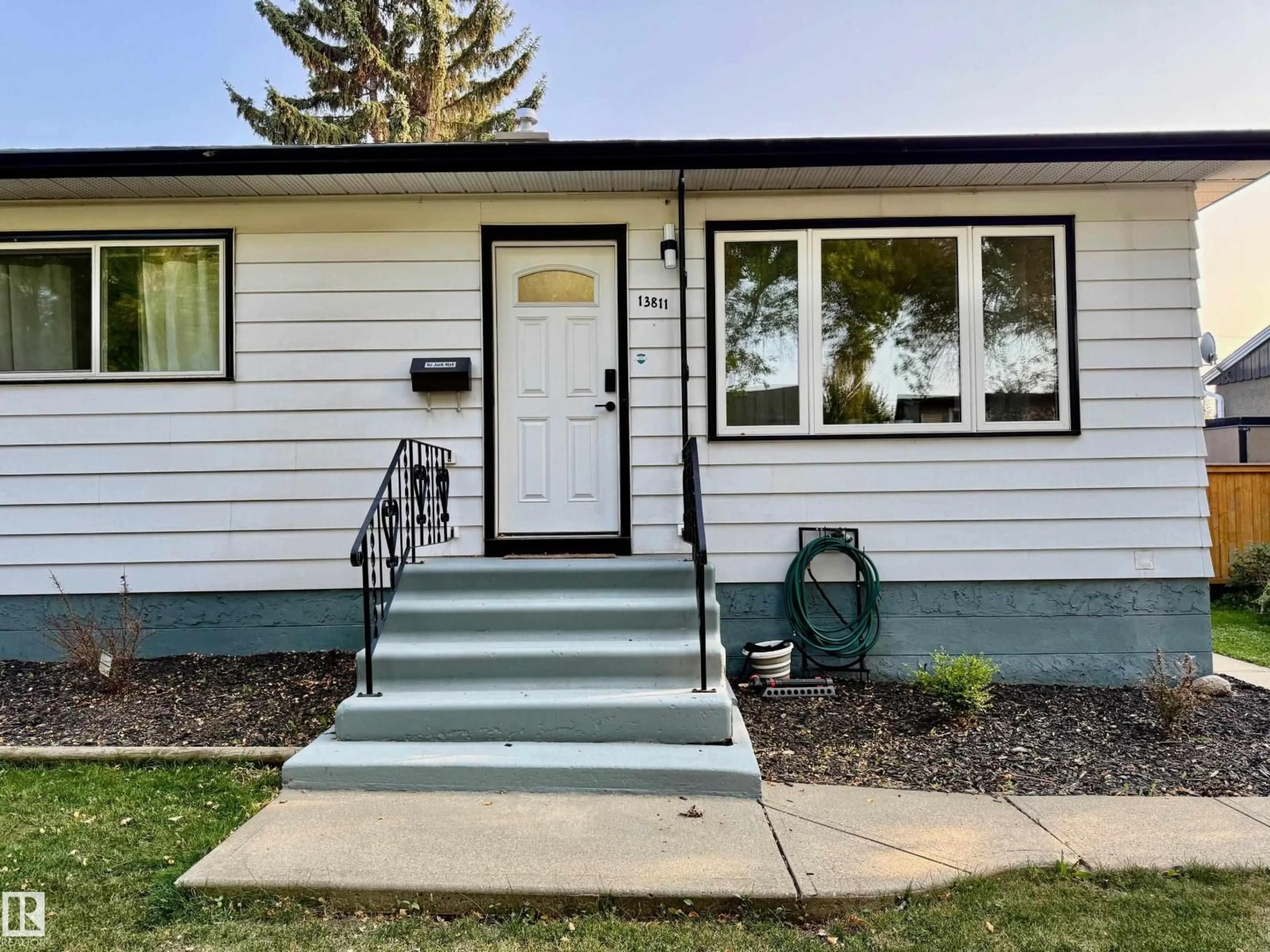 Home with vinyl exterior material, street for 13811 110A AV, Edmonton Alberta T5M2N1
