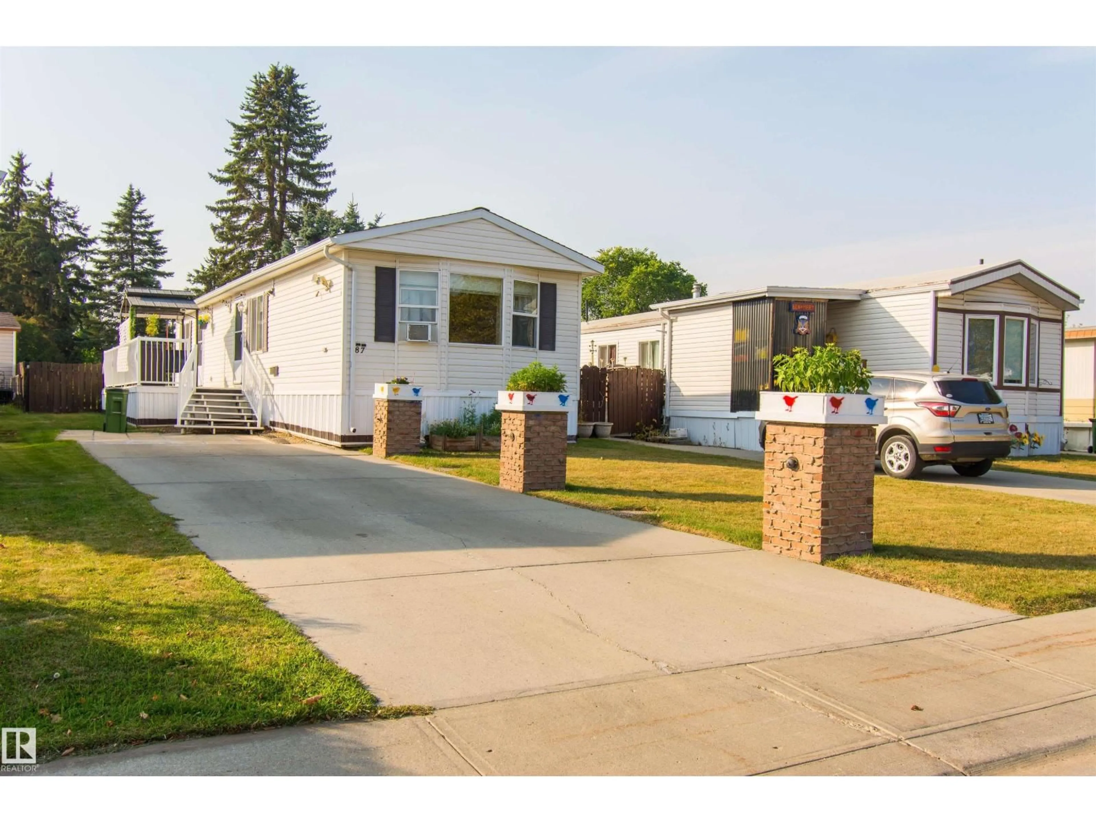 Home with vinyl exterior material, street for #87 - 12604 153 AV, Edmonton Alberta T5X4M7