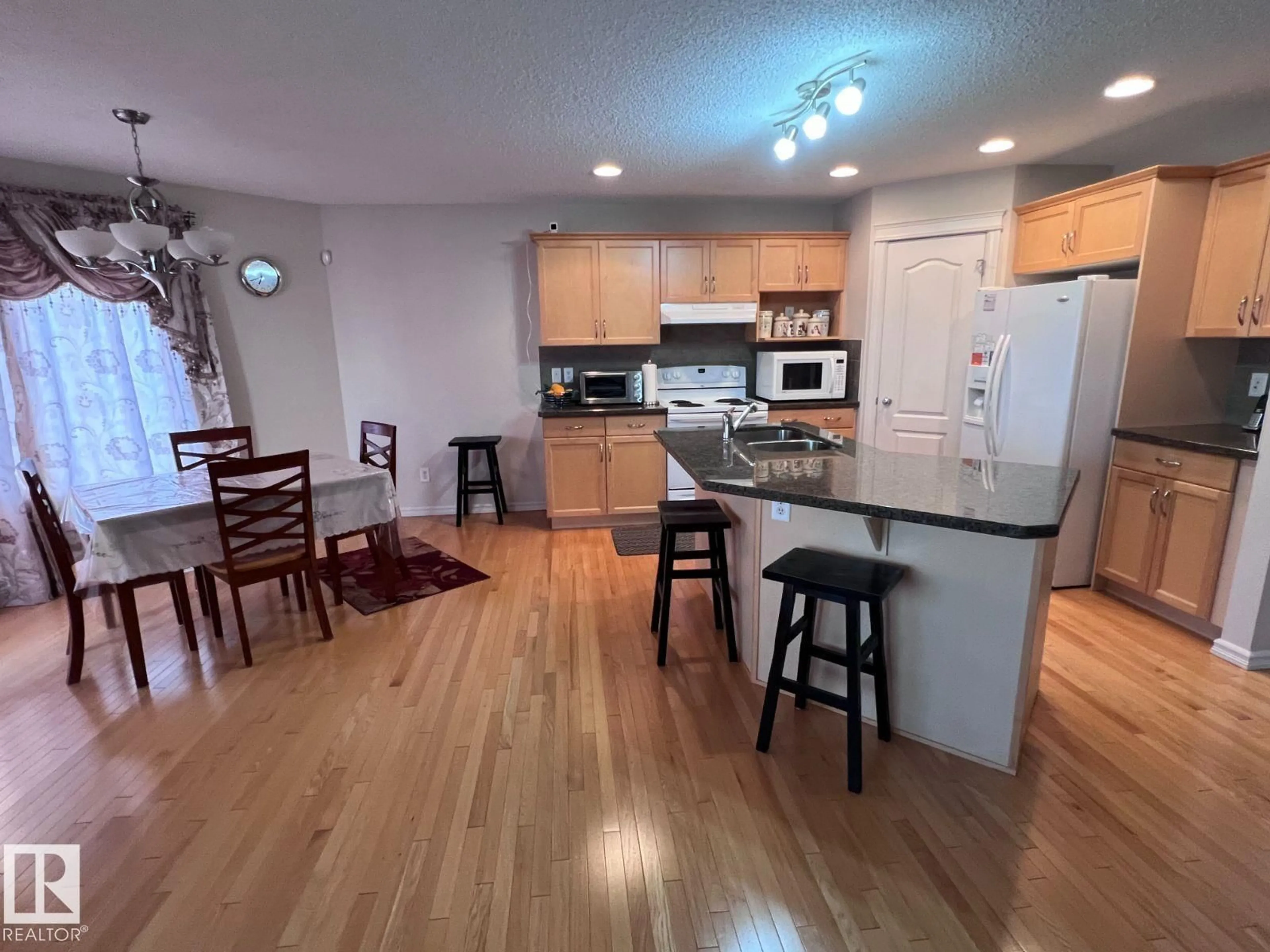 Open concept kitchen, wood/laminate floor for 20707 56 AV, Edmonton Alberta T6M0B7