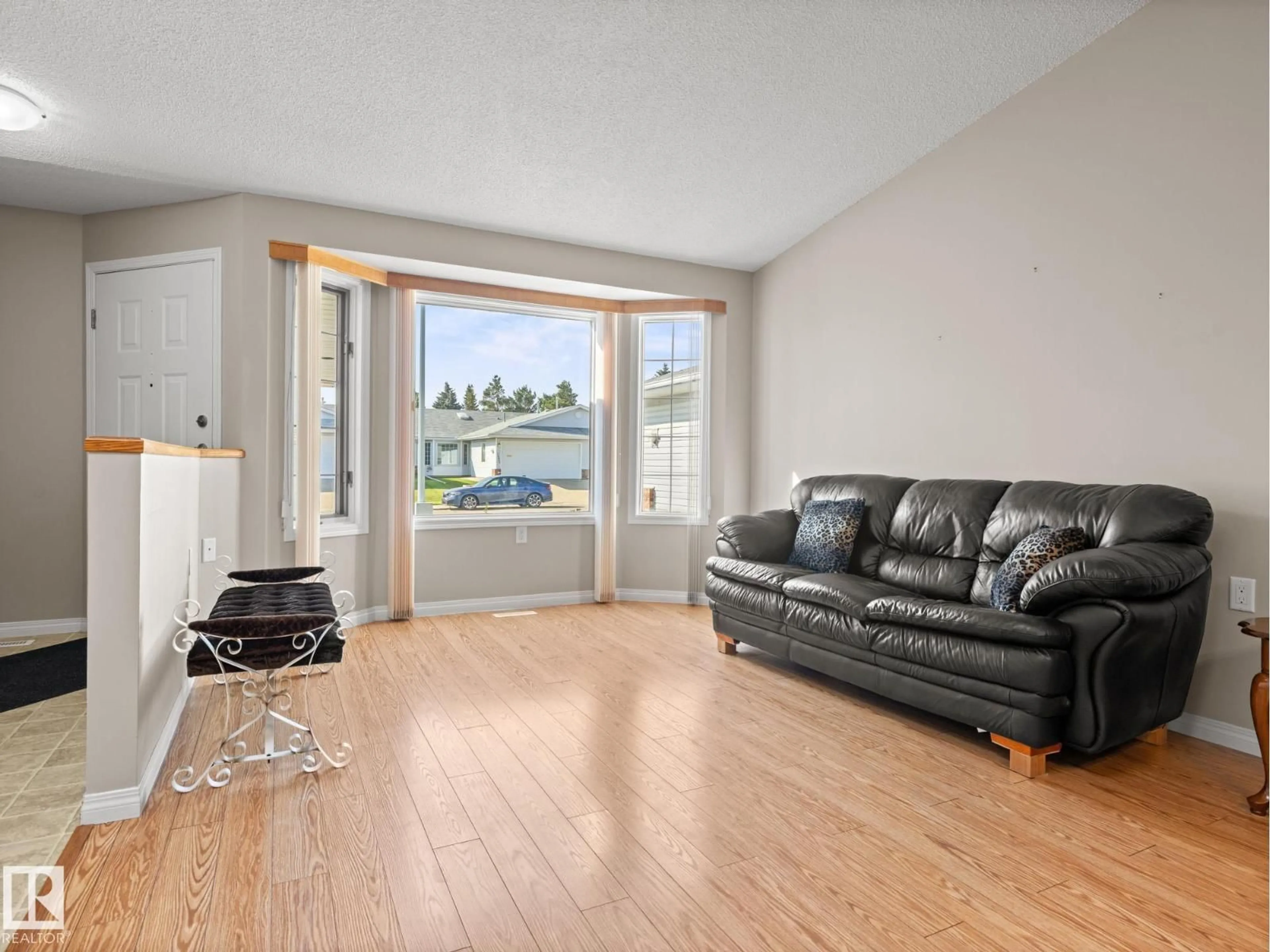 Living room with furniture, wood/laminate floor for 7520 137A AV, Edmonton Alberta T5C3R4