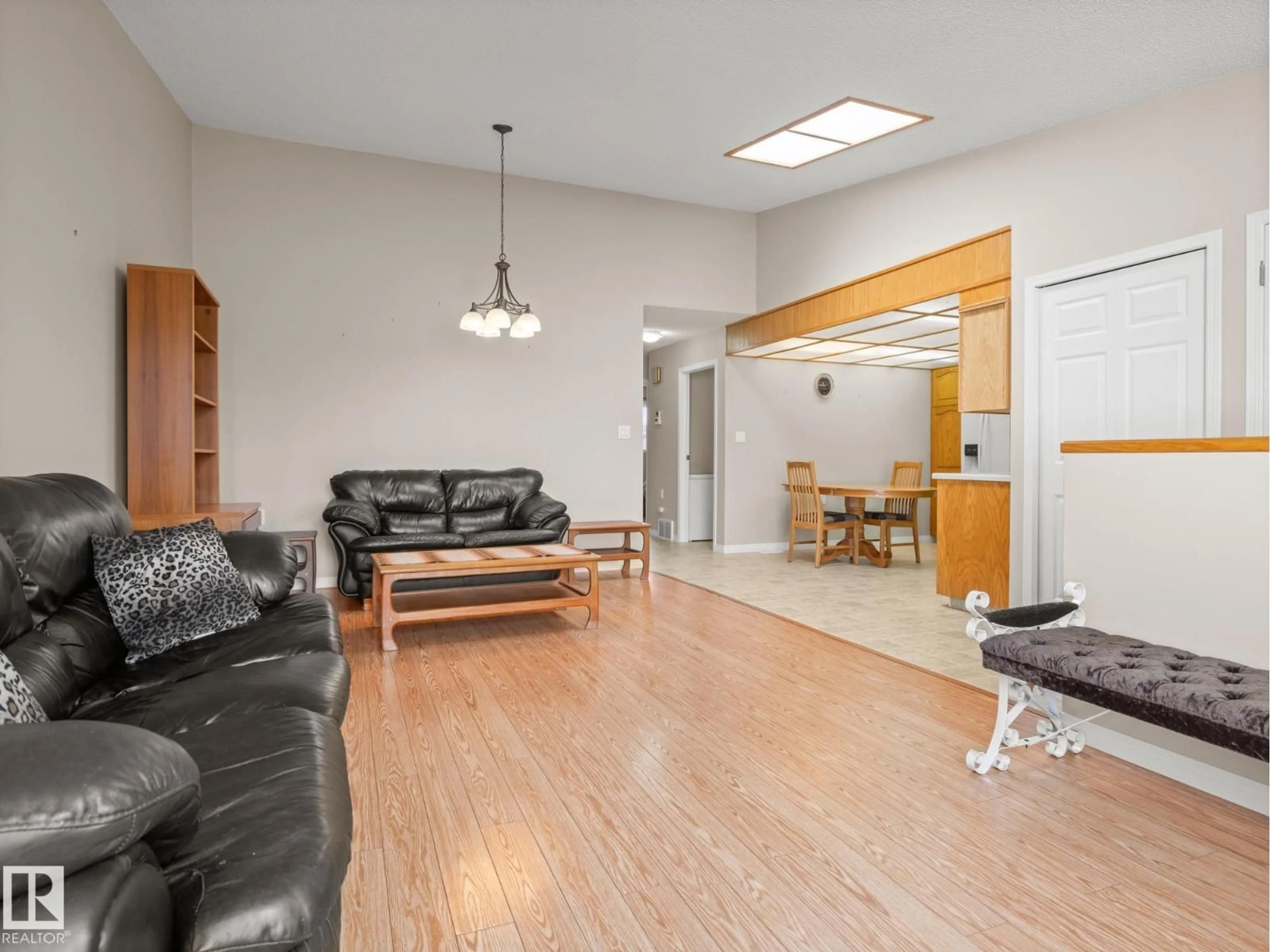 Living room with furniture, wood/laminate floor for 7520 137A AV, Edmonton Alberta T5C3R4