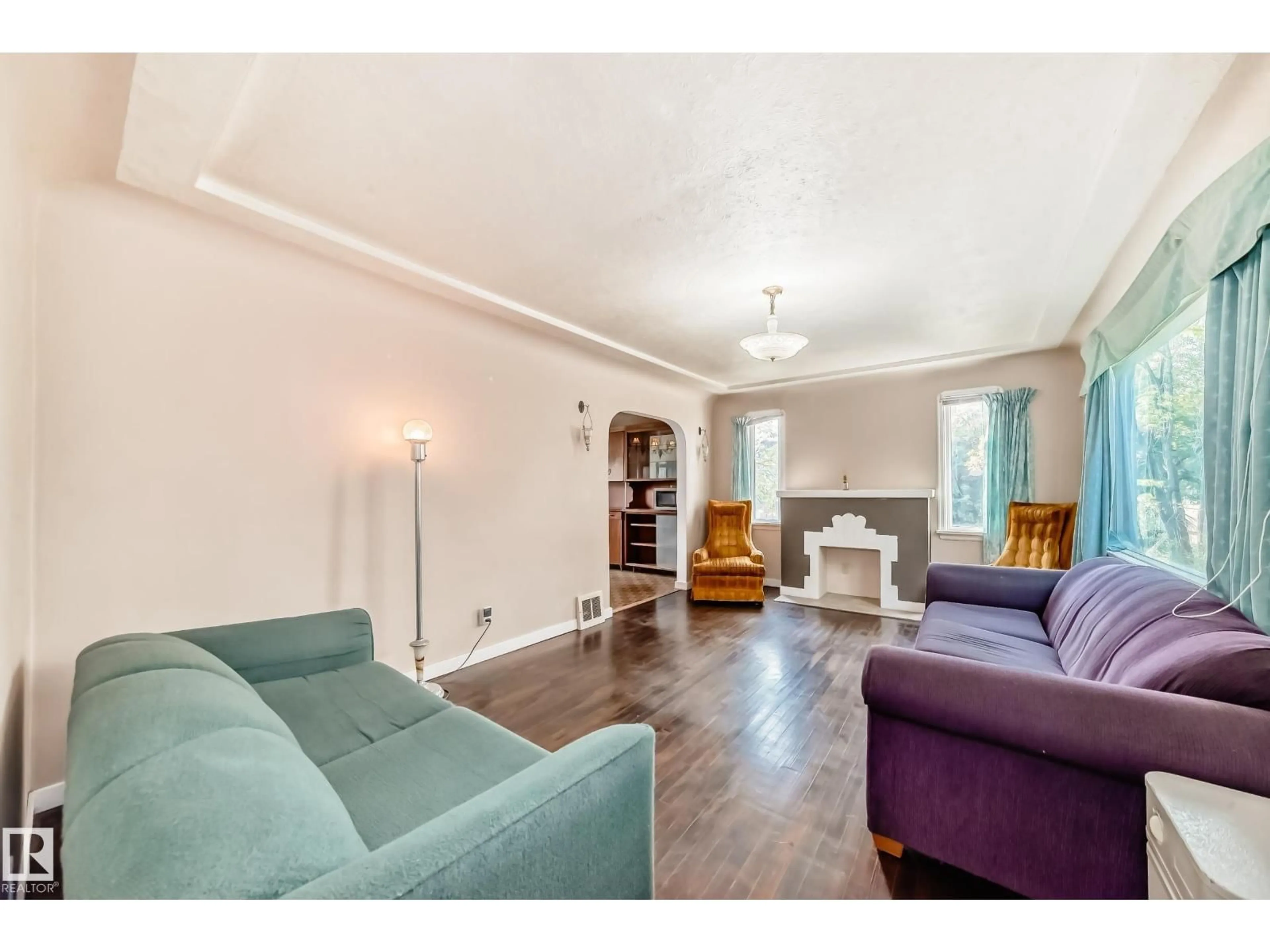 Living room with furniture, wood/laminate floor for 11233 95 ST, Edmonton Alberta T5G1K8