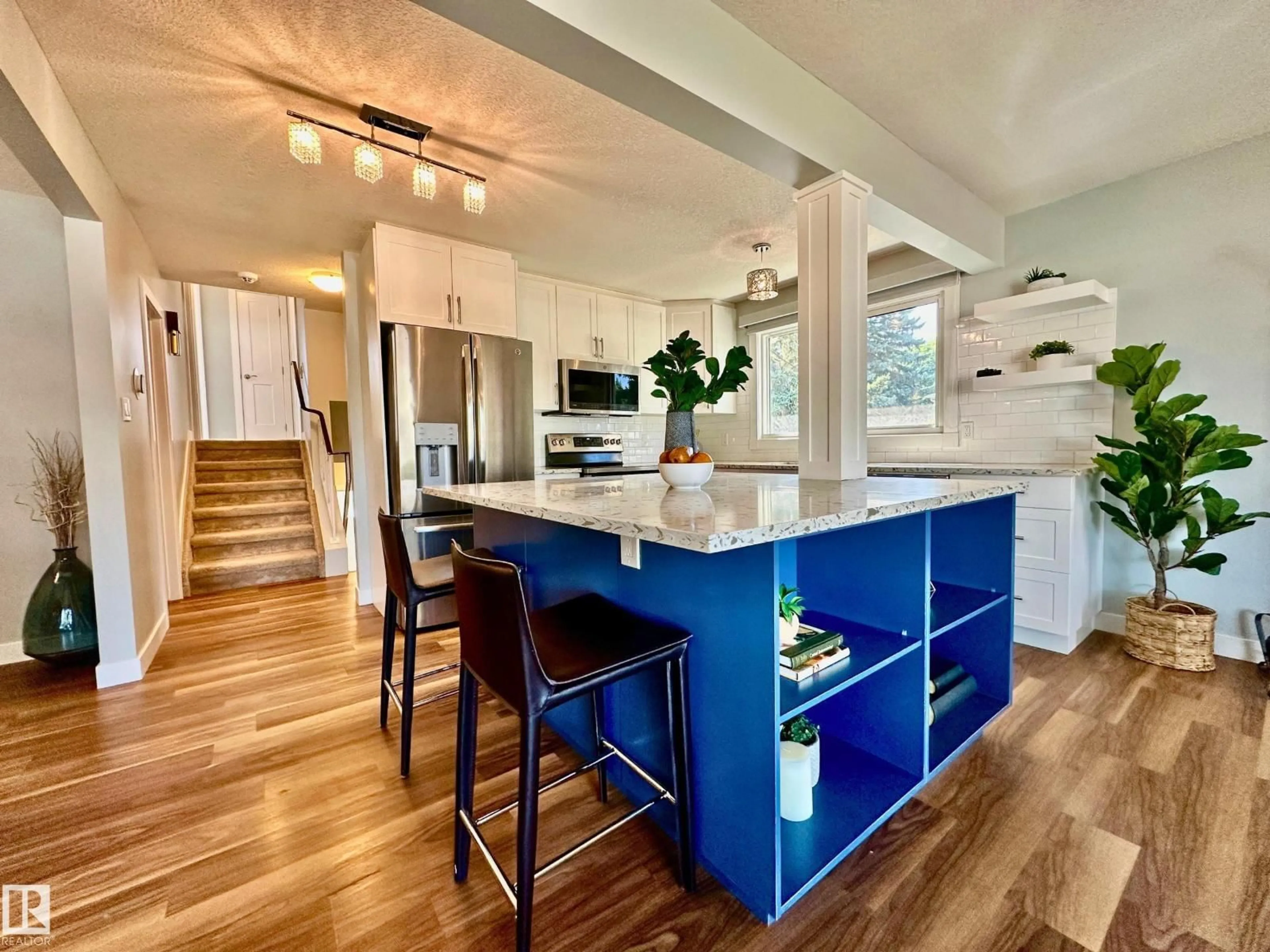 Open concept kitchen, wood/laminate floor for 8517 86 AV, Edmonton Alberta T6C1J4