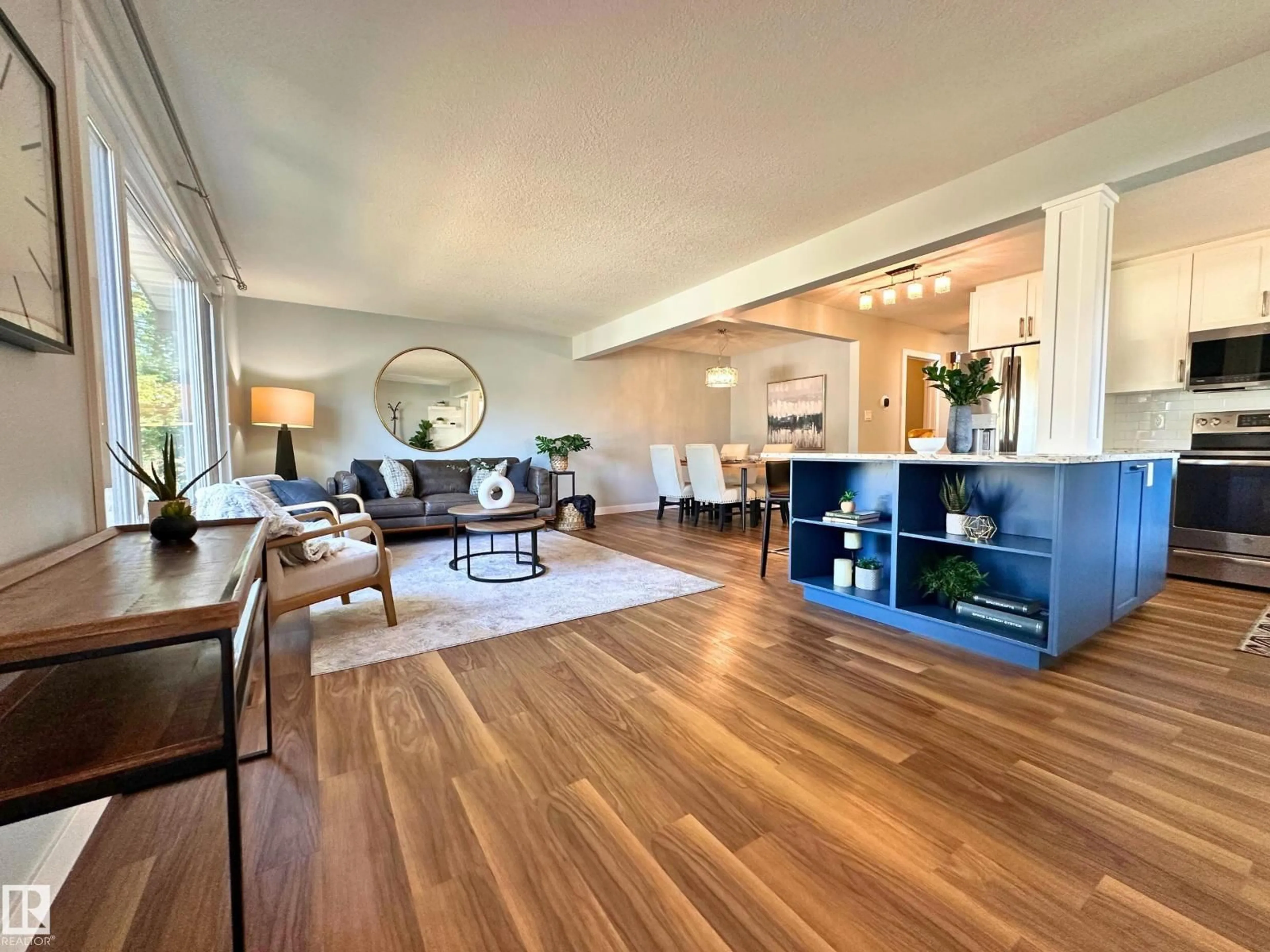 Living room with furniture, wood/laminate floor for 8517 86 AV, Edmonton Alberta T6C1J4