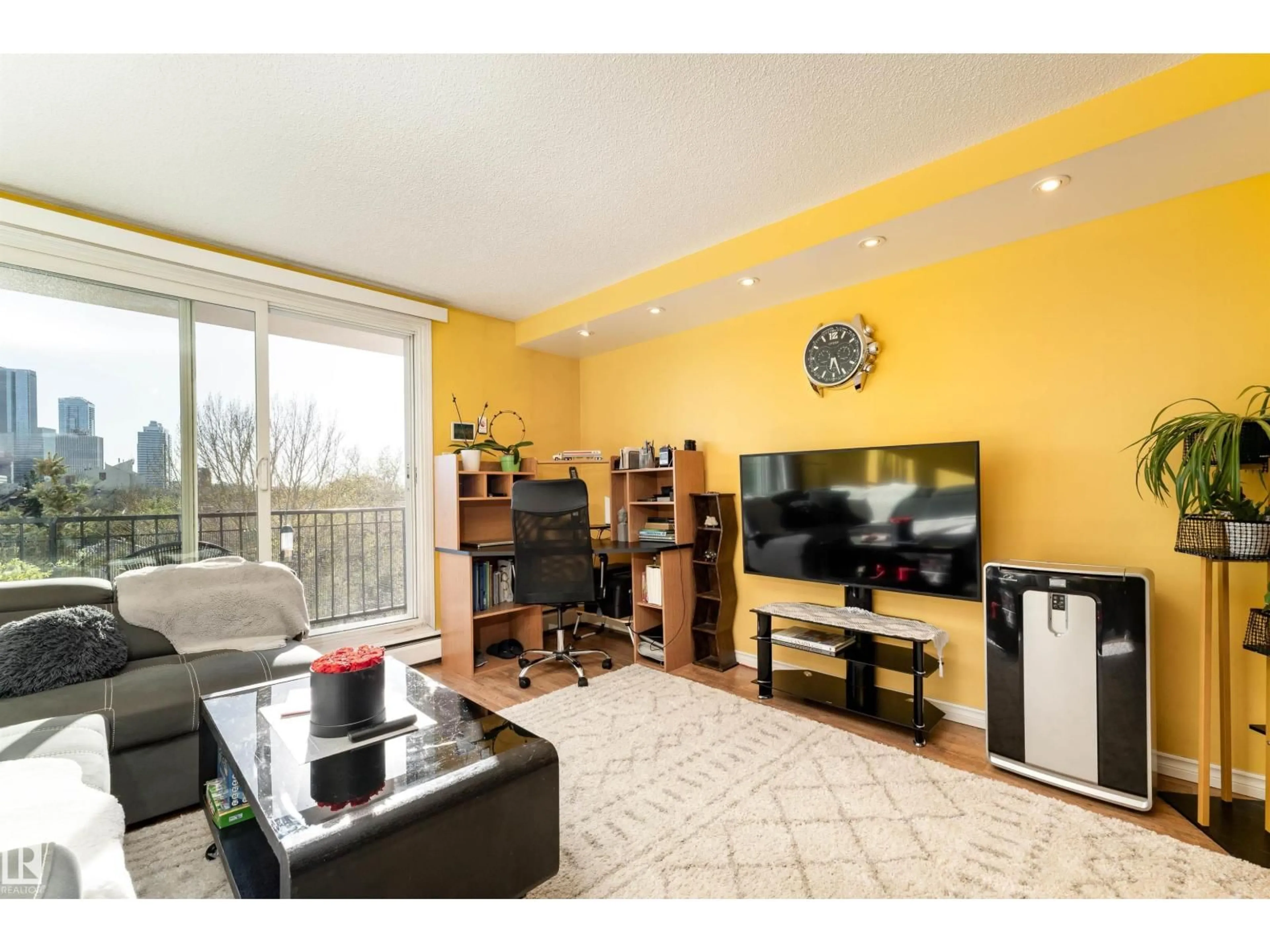 Living room with furniture, wood/laminate floor for 9028 JASPER AV, Edmonton Alberta T5H3Y6
