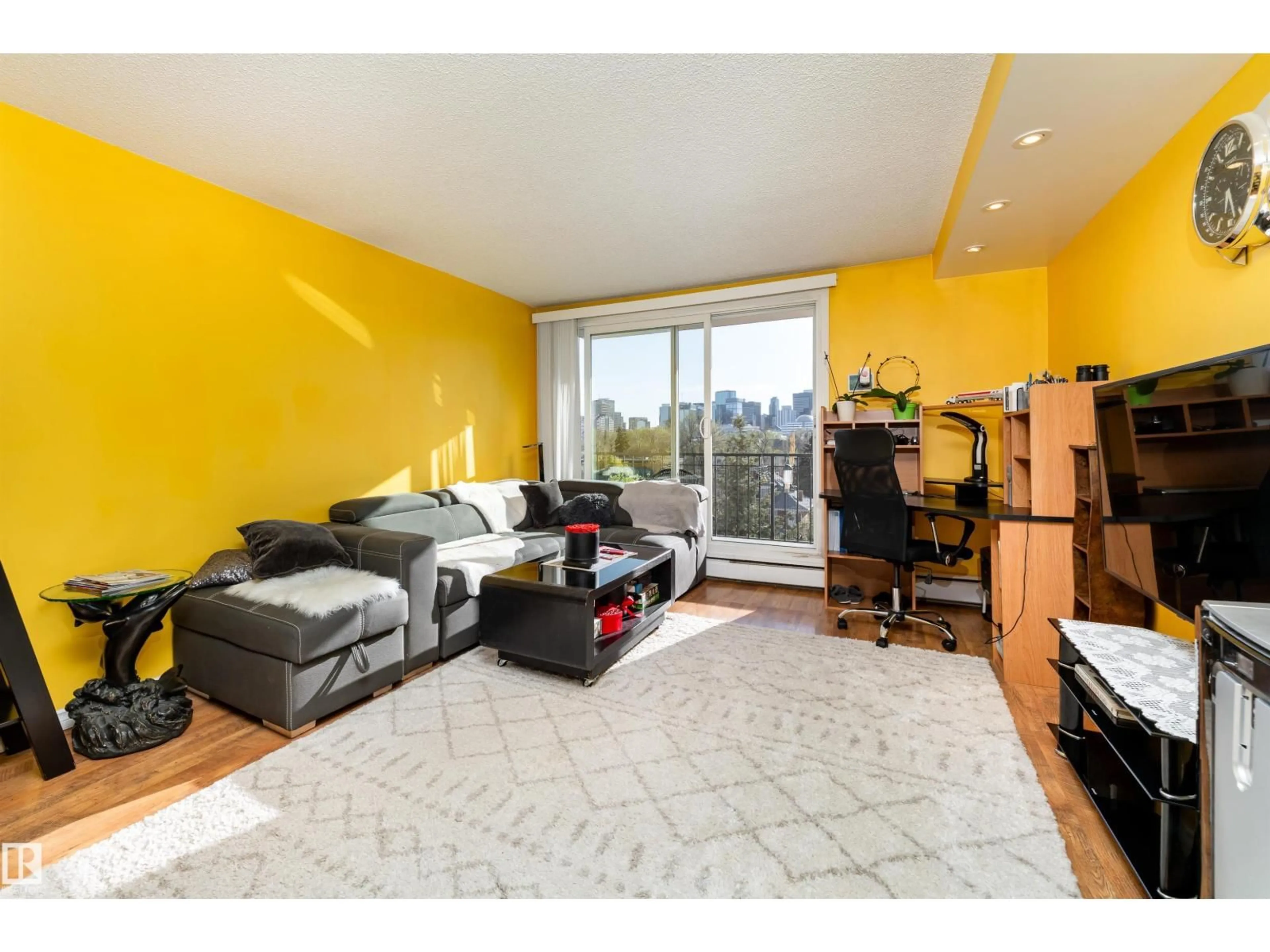 Living room with furniture, wood/laminate floor for 9028 JASPER AV, Edmonton Alberta T5H3Y6