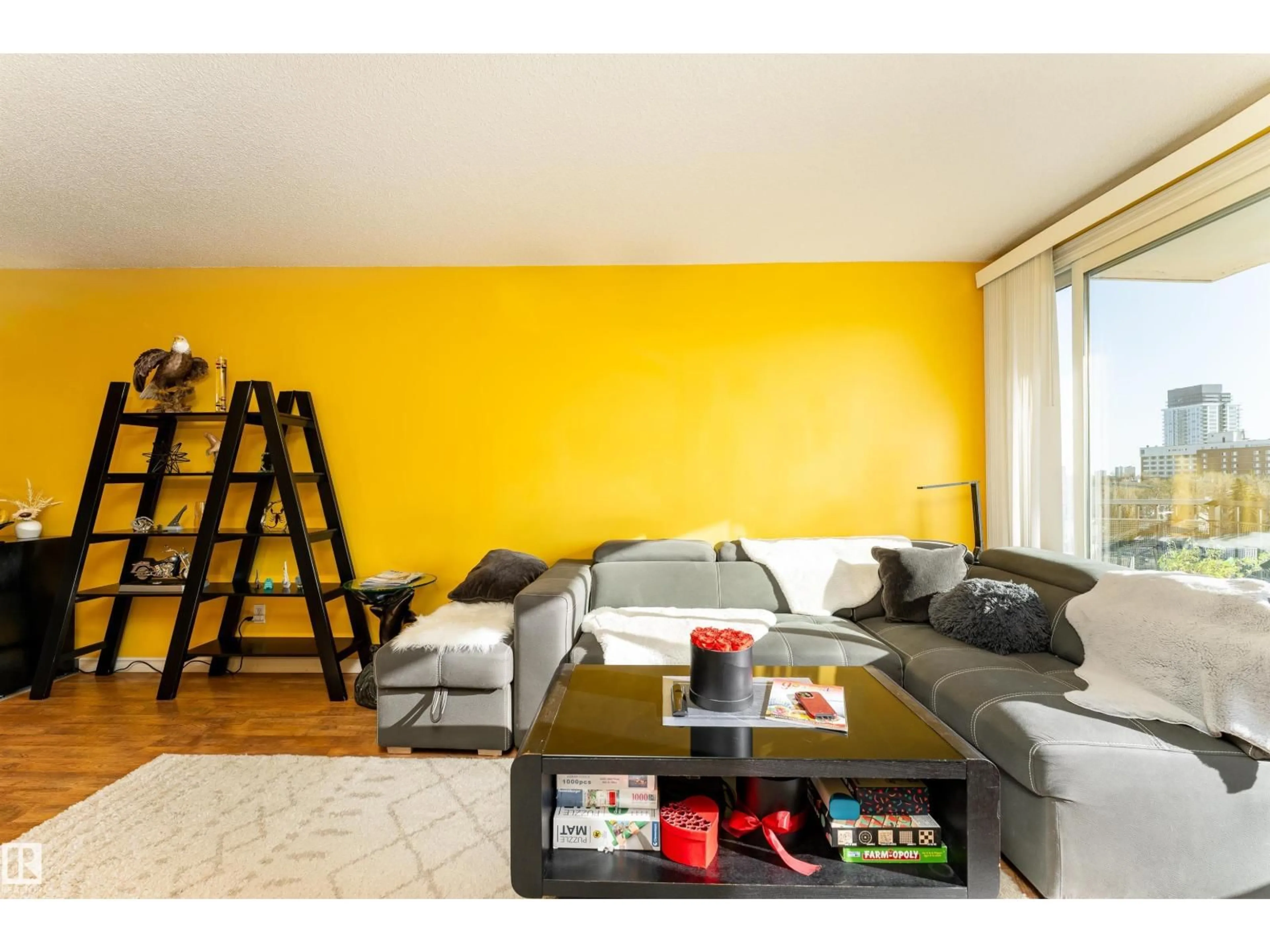 Living room with furniture, wood/laminate floor for 9028 JASPER AV, Edmonton Alberta T5H3Y6