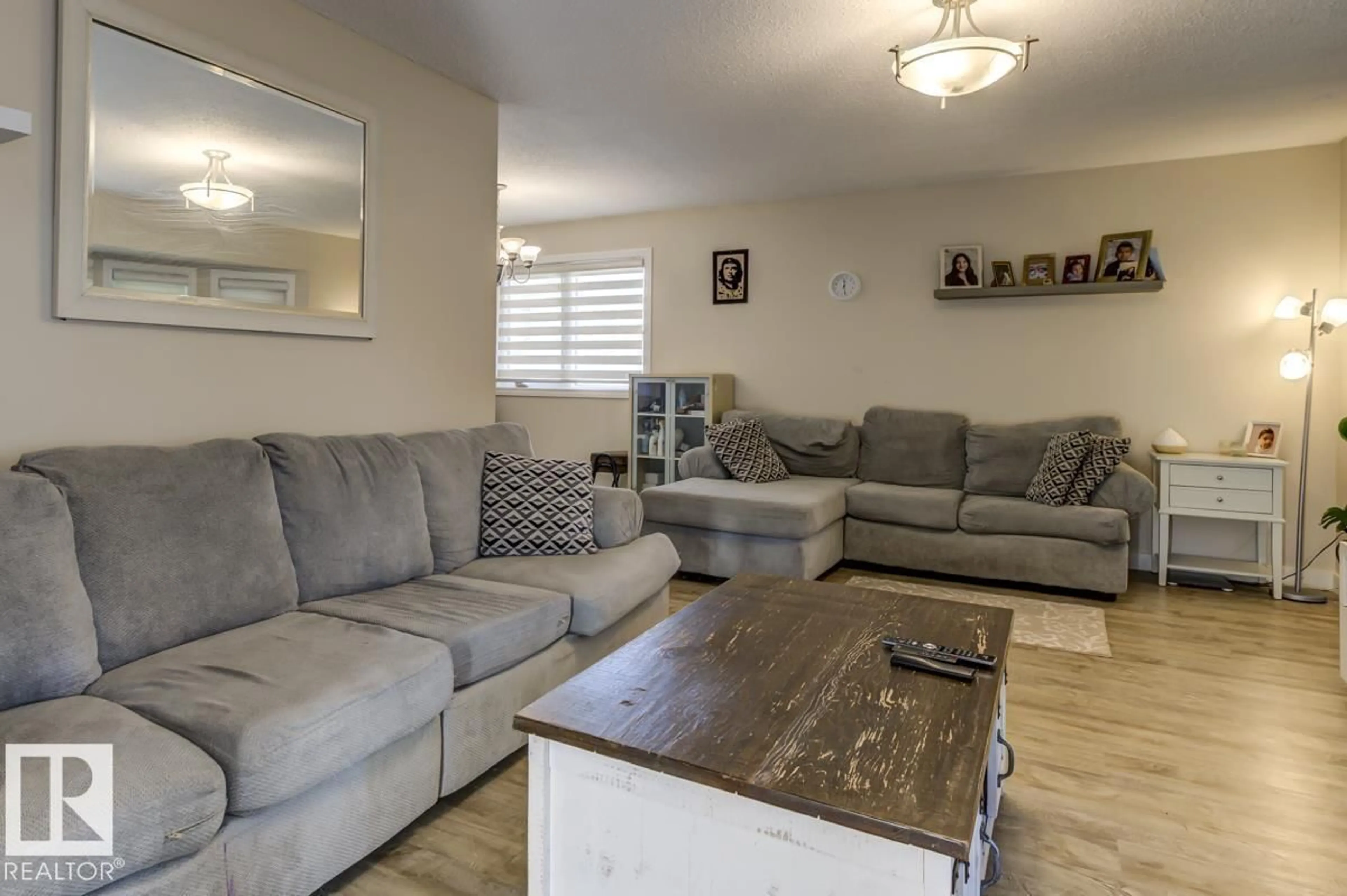 Living room with furniture, wood/laminate floor for 16920 110 ST, Edmonton Alberta T5X2N8