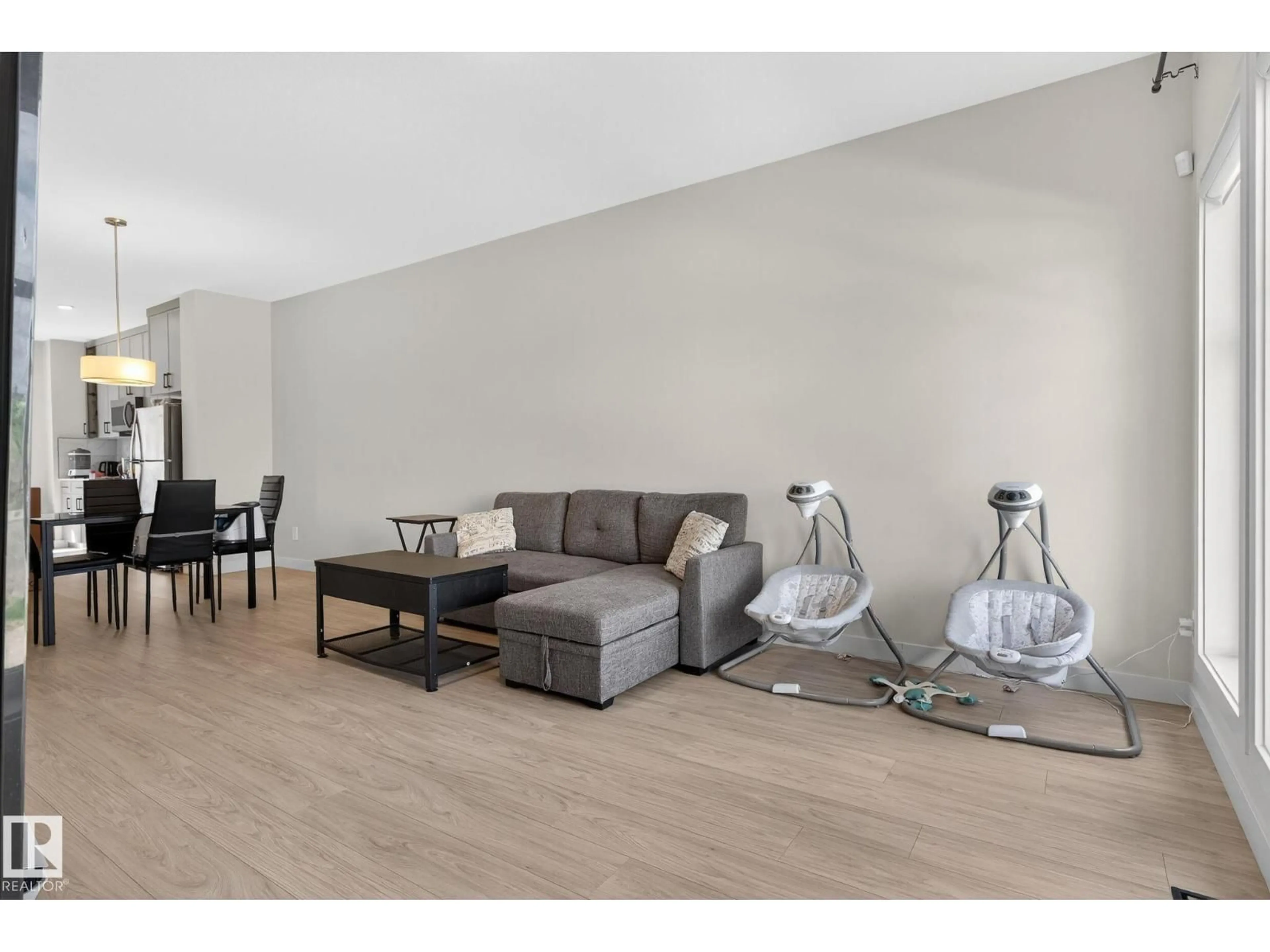 Living room with furniture, wood/laminate floor for NW - 7133 178 AV, Edmonton Alberta T5Z0T8