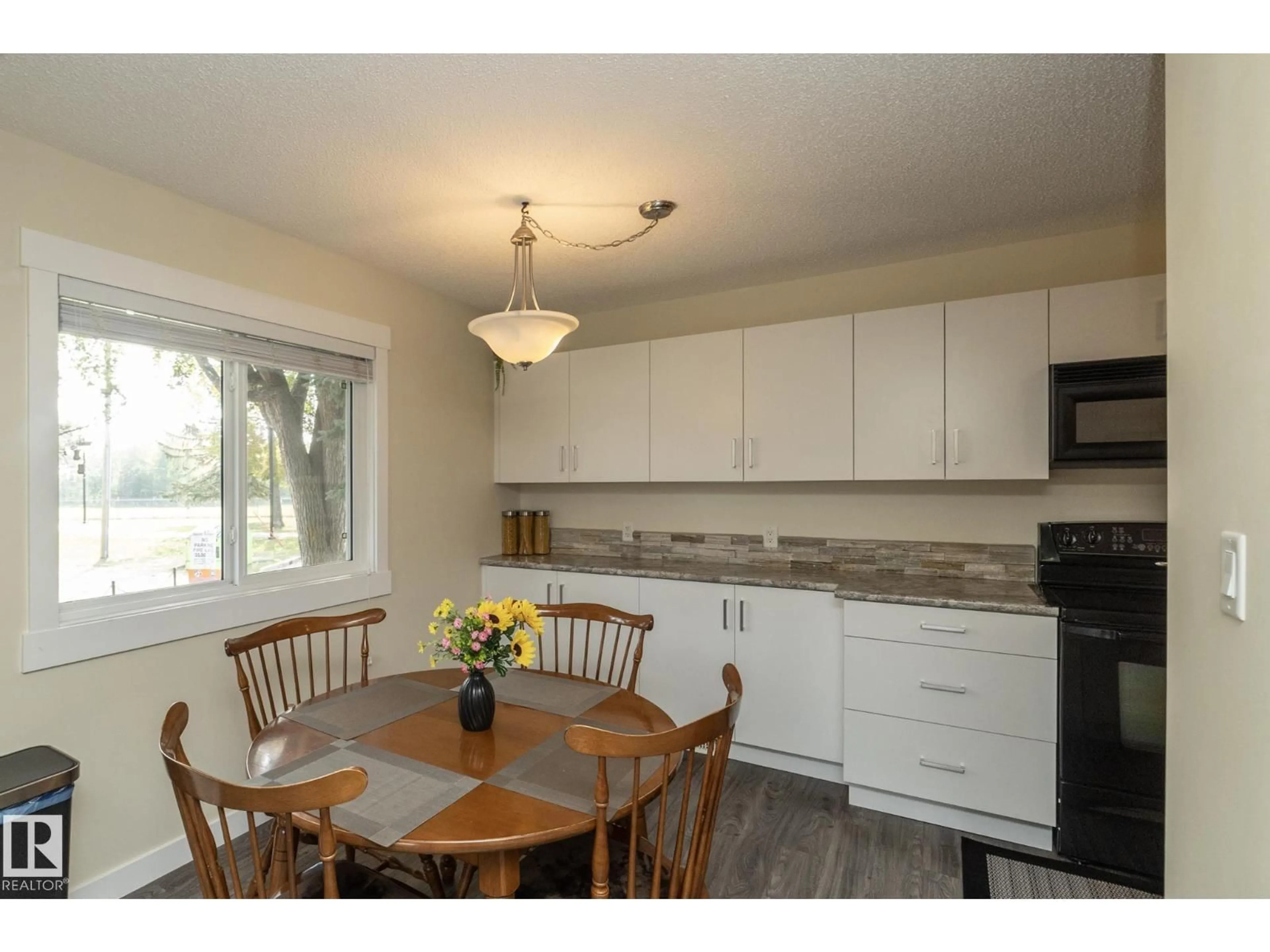 Open concept kitchen, wood/laminate floor for 1 ATHABASCA AC, Devon Alberta T9G1L8