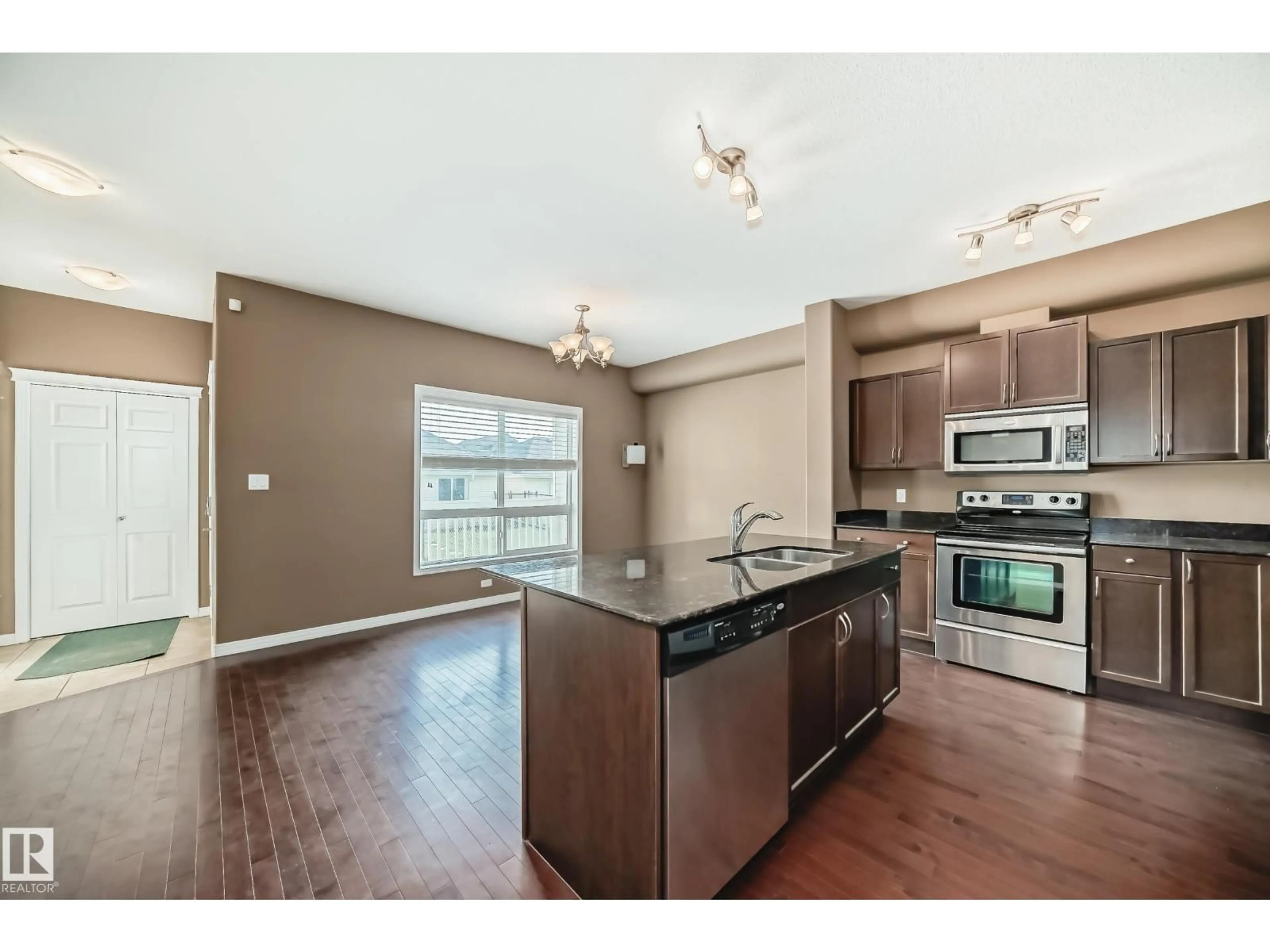 Open concept kitchen, wood/laminate floor for #8 - 4367 VETERANS WY, Edmonton Alberta T5E6N4
