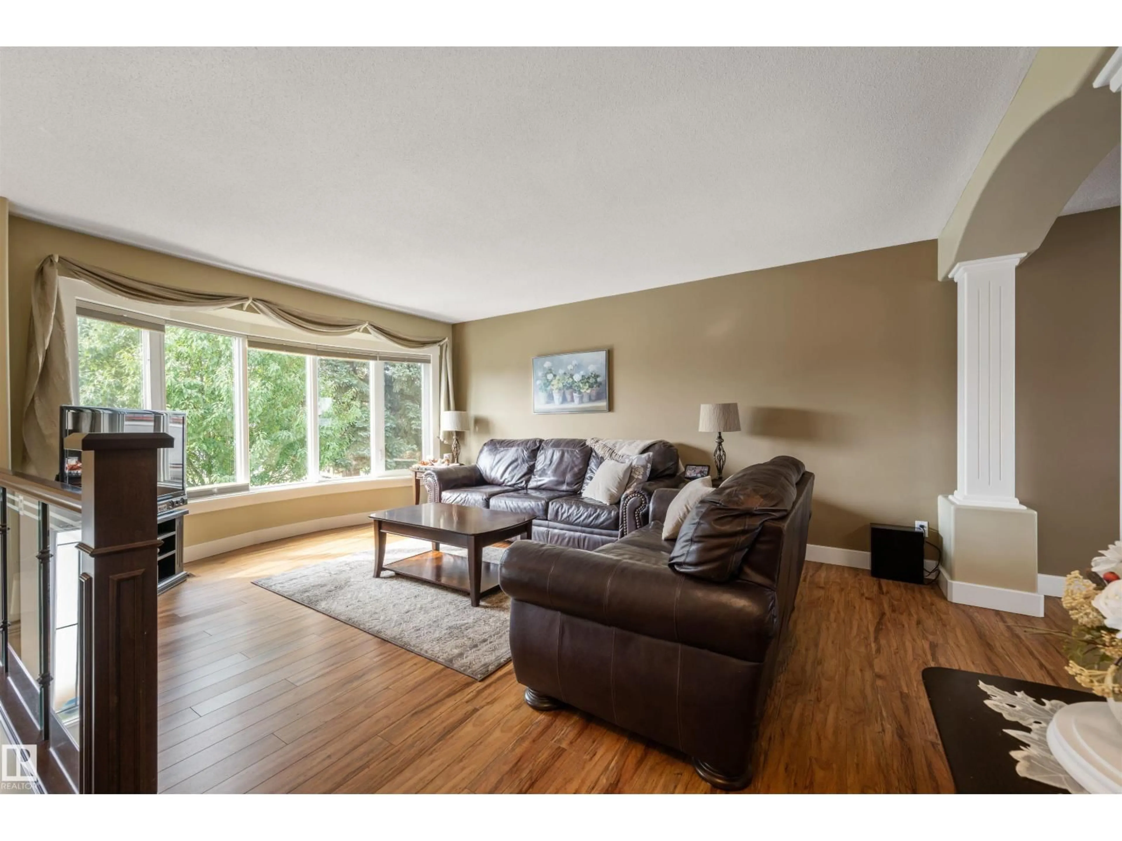 Living room with furniture, wood/laminate floor for 4024 19 AV, Edmonton Alberta T6L3M7