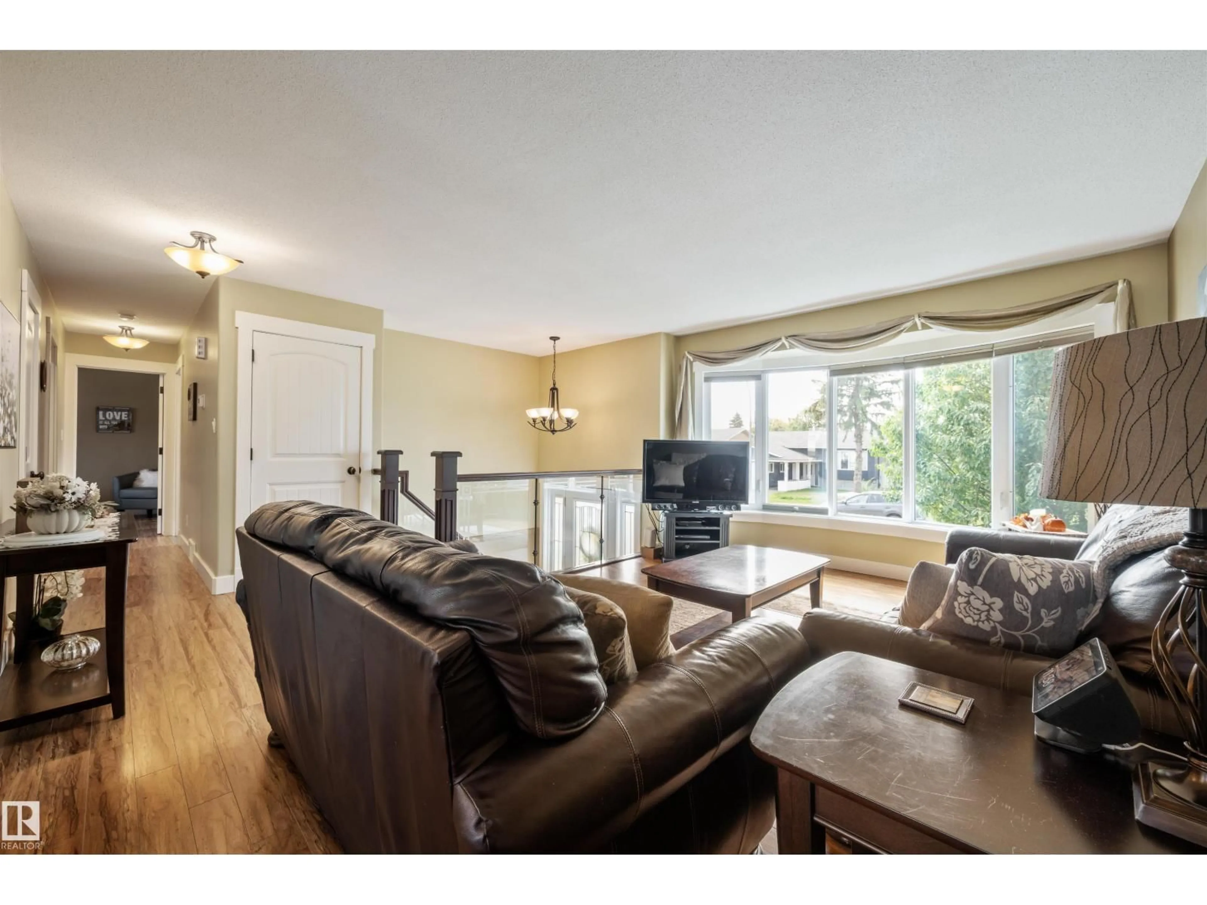 Living room with furniture, wood/laminate floor for 4024 19 AV, Edmonton Alberta T6L3M7