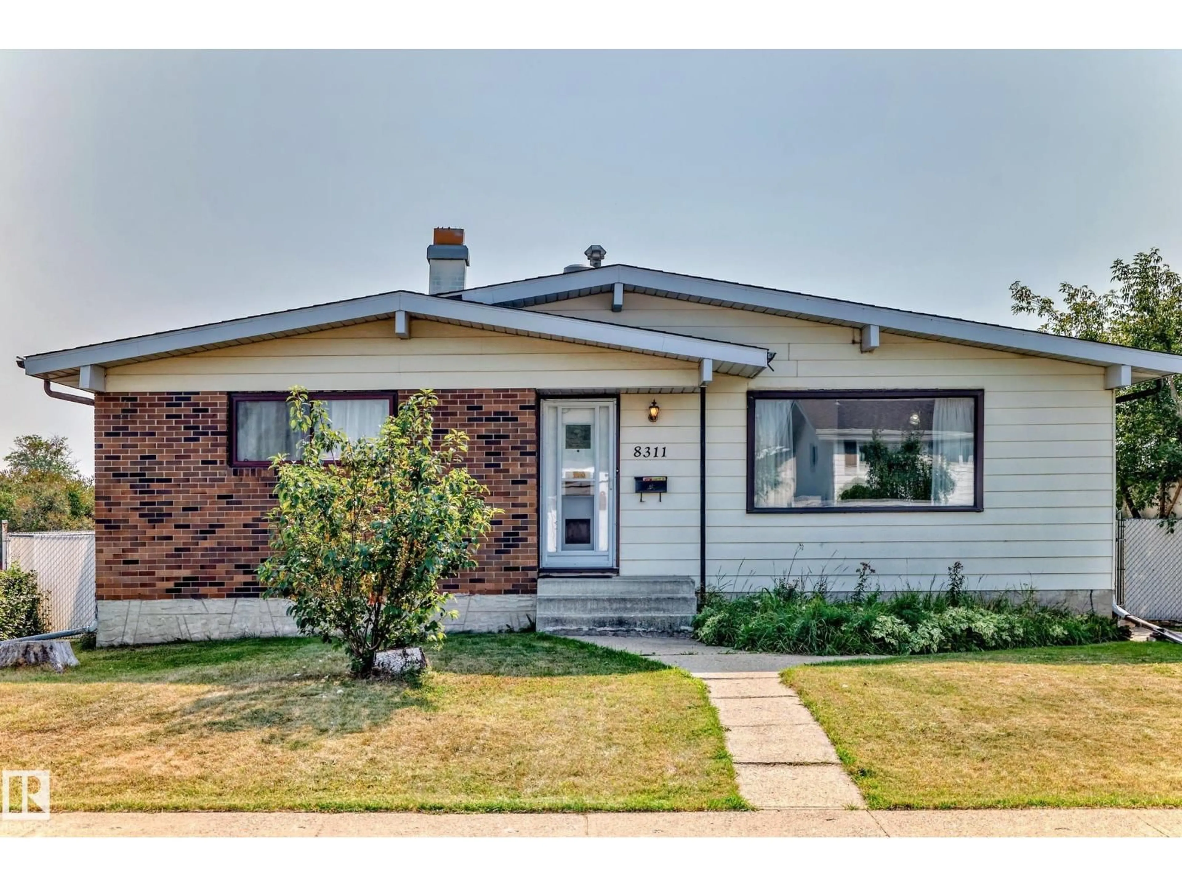 Home with brick exterior material, street for 8311 150 AV, Edmonton Alberta T5E1B9