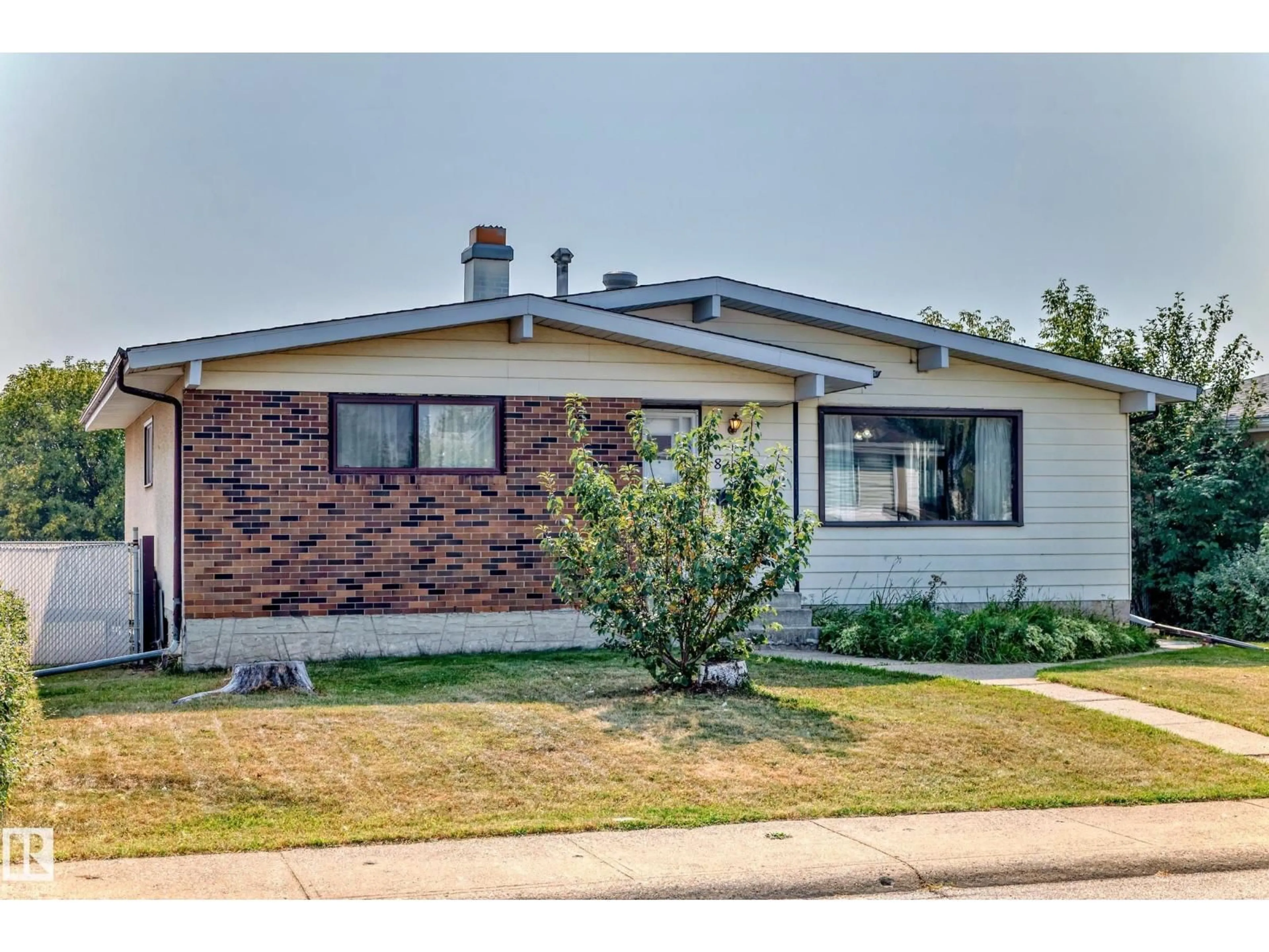 Home with vinyl exterior material, street for 8311 150 AV, Edmonton Alberta T5E1B9