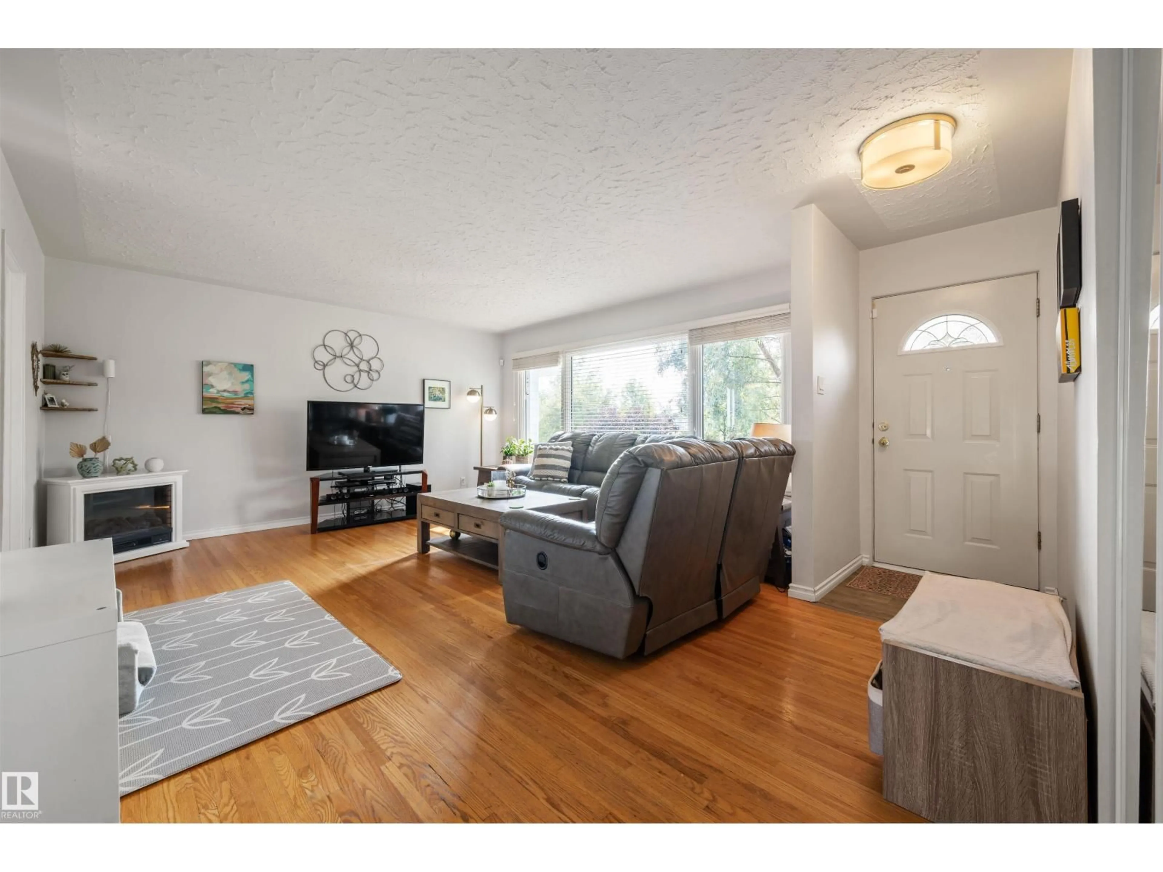 Living room with furniture, wood/laminate floor for 7920 76 AV, Edmonton Alberta T6C0H5