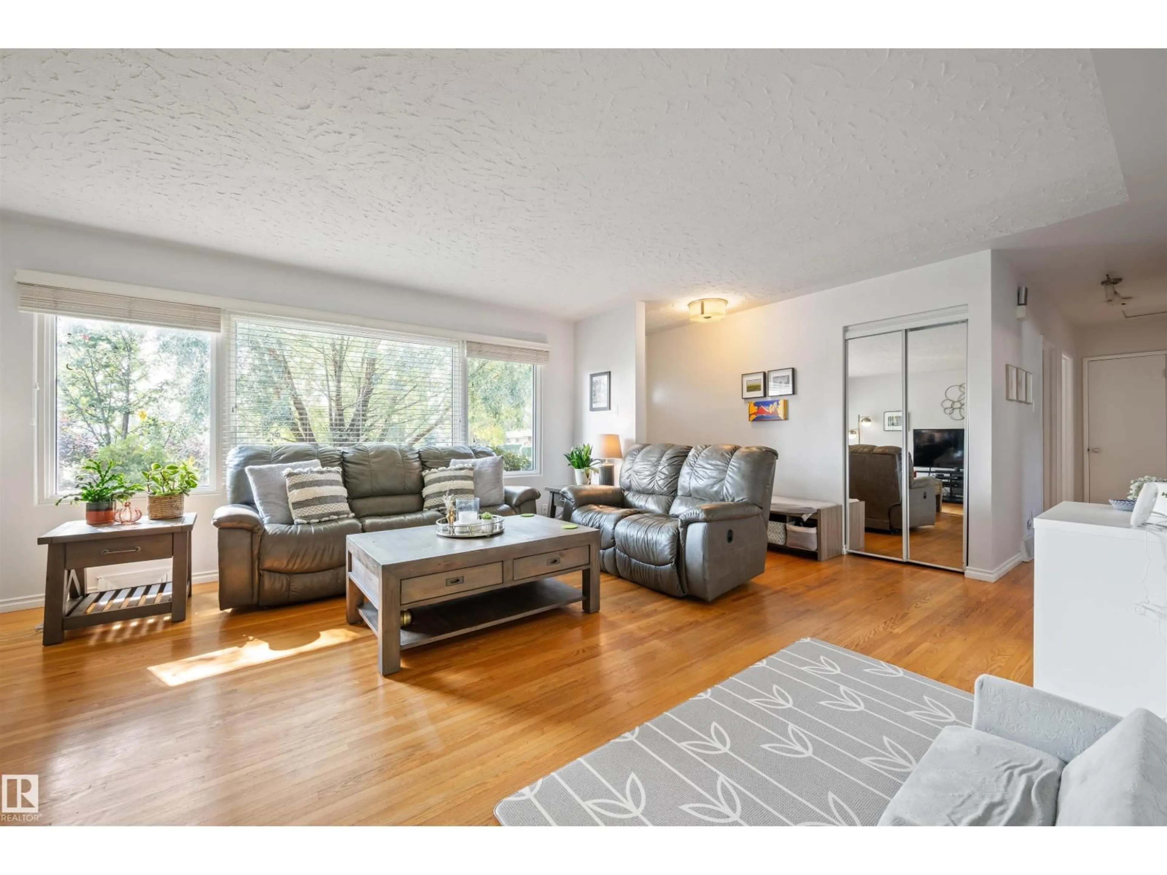 Living room with furniture, wood/laminate floor for 7920 76 AV, Edmonton Alberta T6C0H5