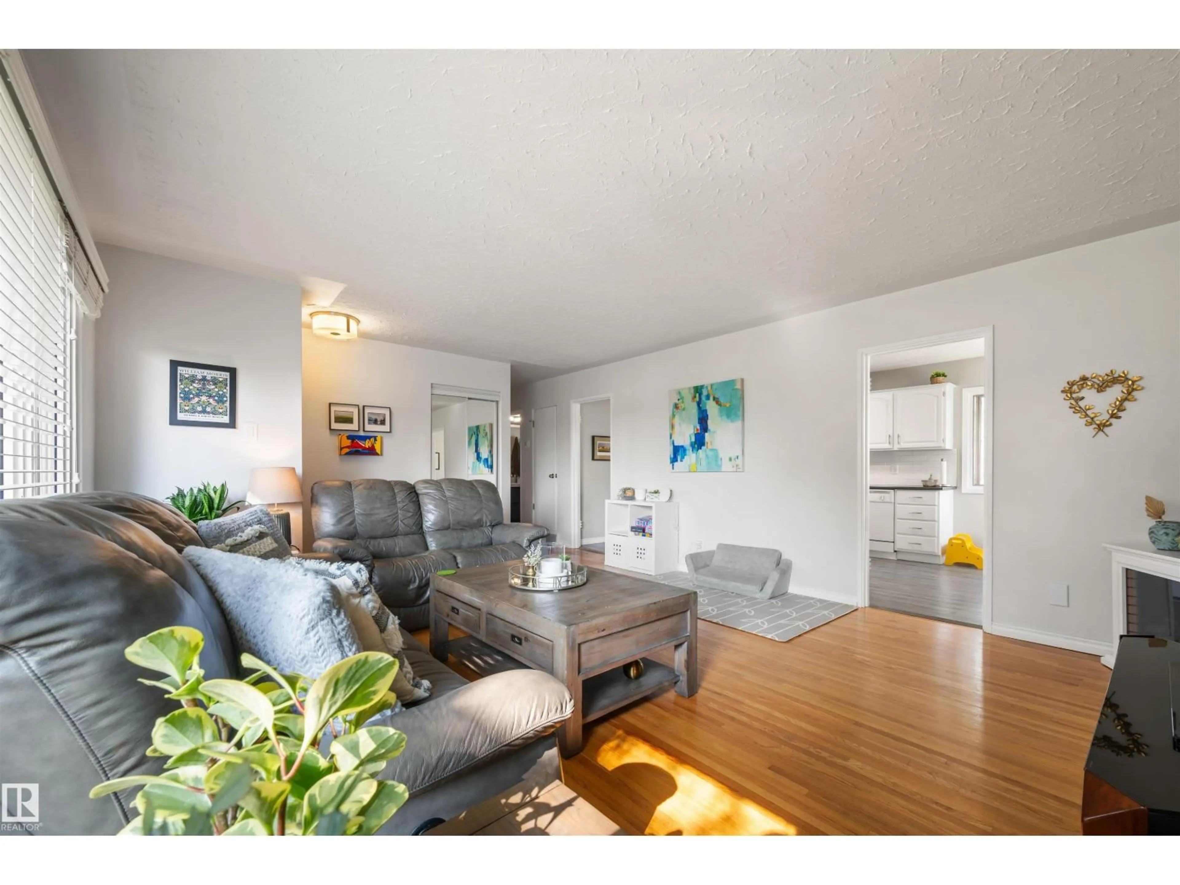 Living room with furniture, wood/laminate floor for 7920 76 AV, Edmonton Alberta T6C0H5