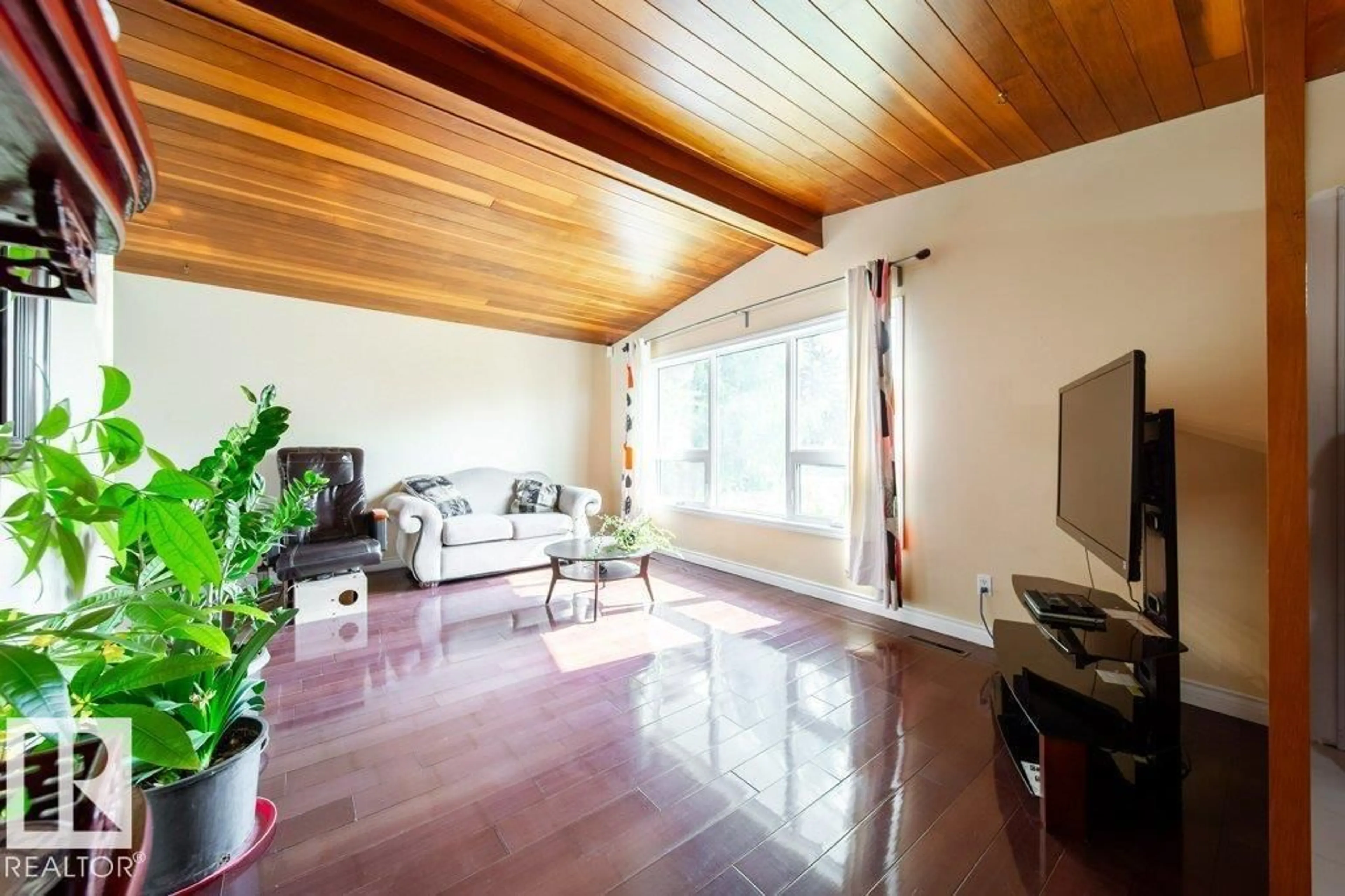 Living room with furniture, wood/laminate floor for 6916 151 AV, Edmonton Alberta T5C2Y7