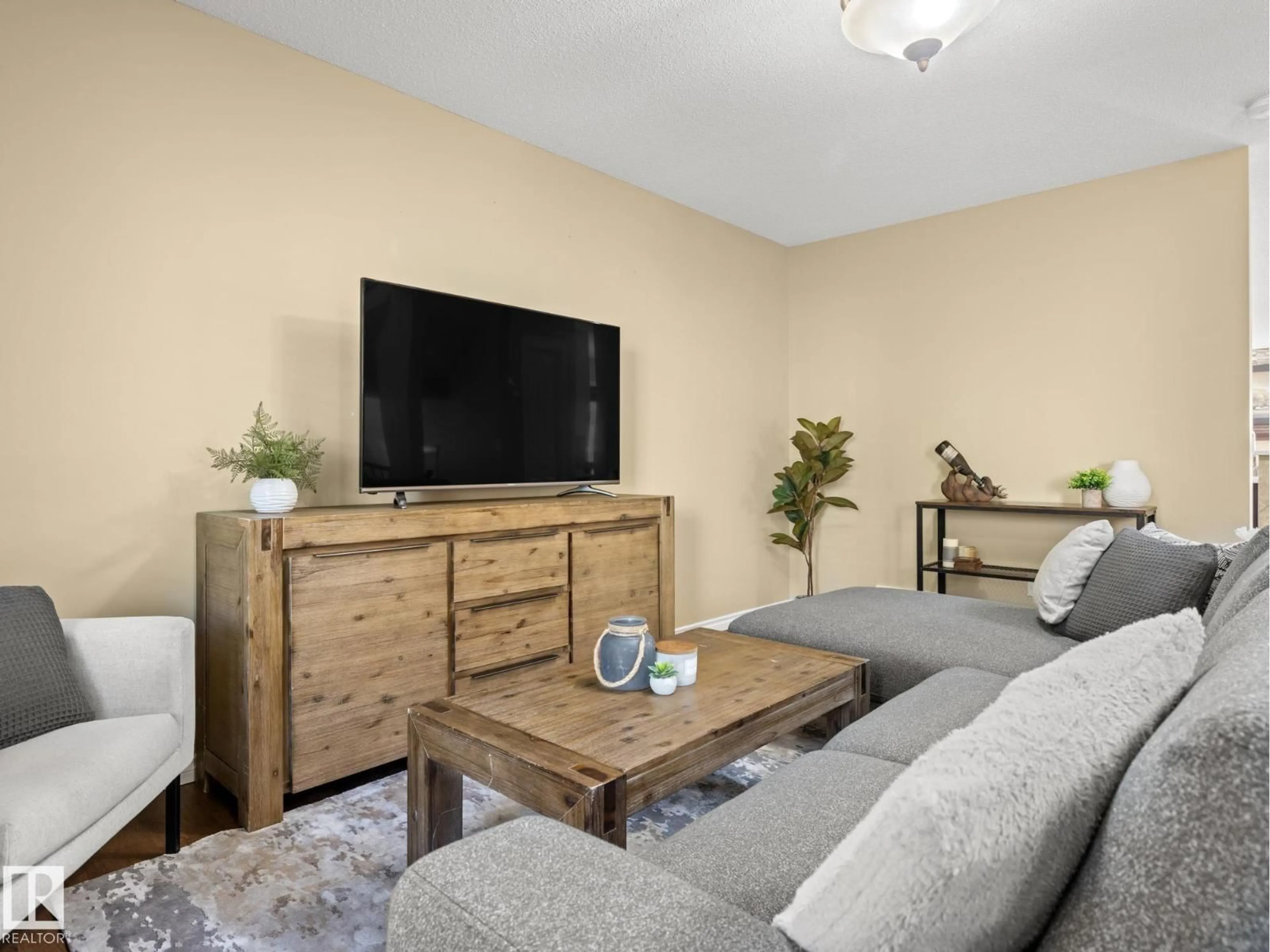 Living room with furniture, wood/laminate floor for 273 MCCONACHIE DR, Edmonton Alberta T5Y0M7