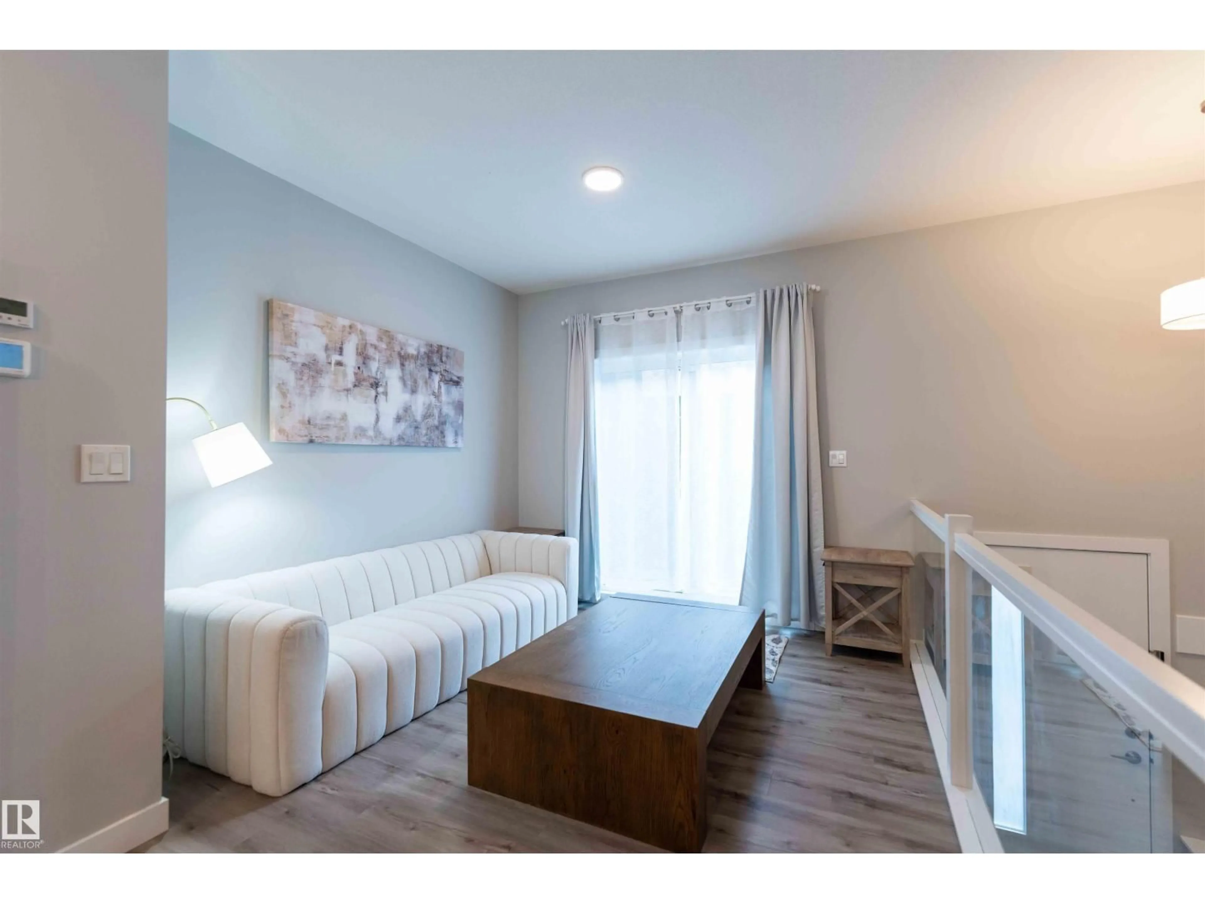 Living room with furniture, wood/laminate floor for 21 1729 KEENE CR SW, Edmonton Alberta T6W4B6