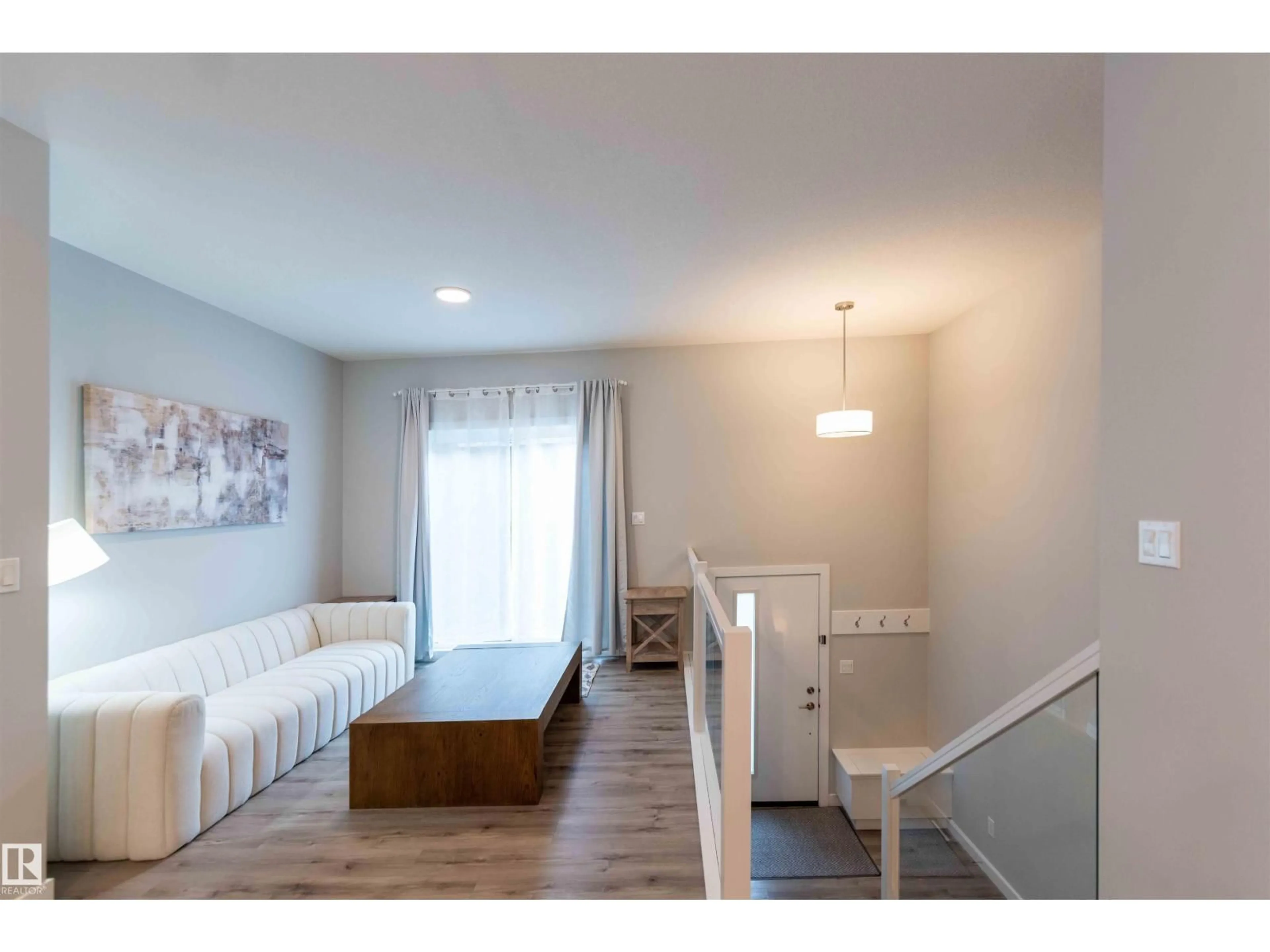 Living room with furniture, wood/laminate floor for 21 1729 KEENE CR SW, Edmonton Alberta T6W4B6