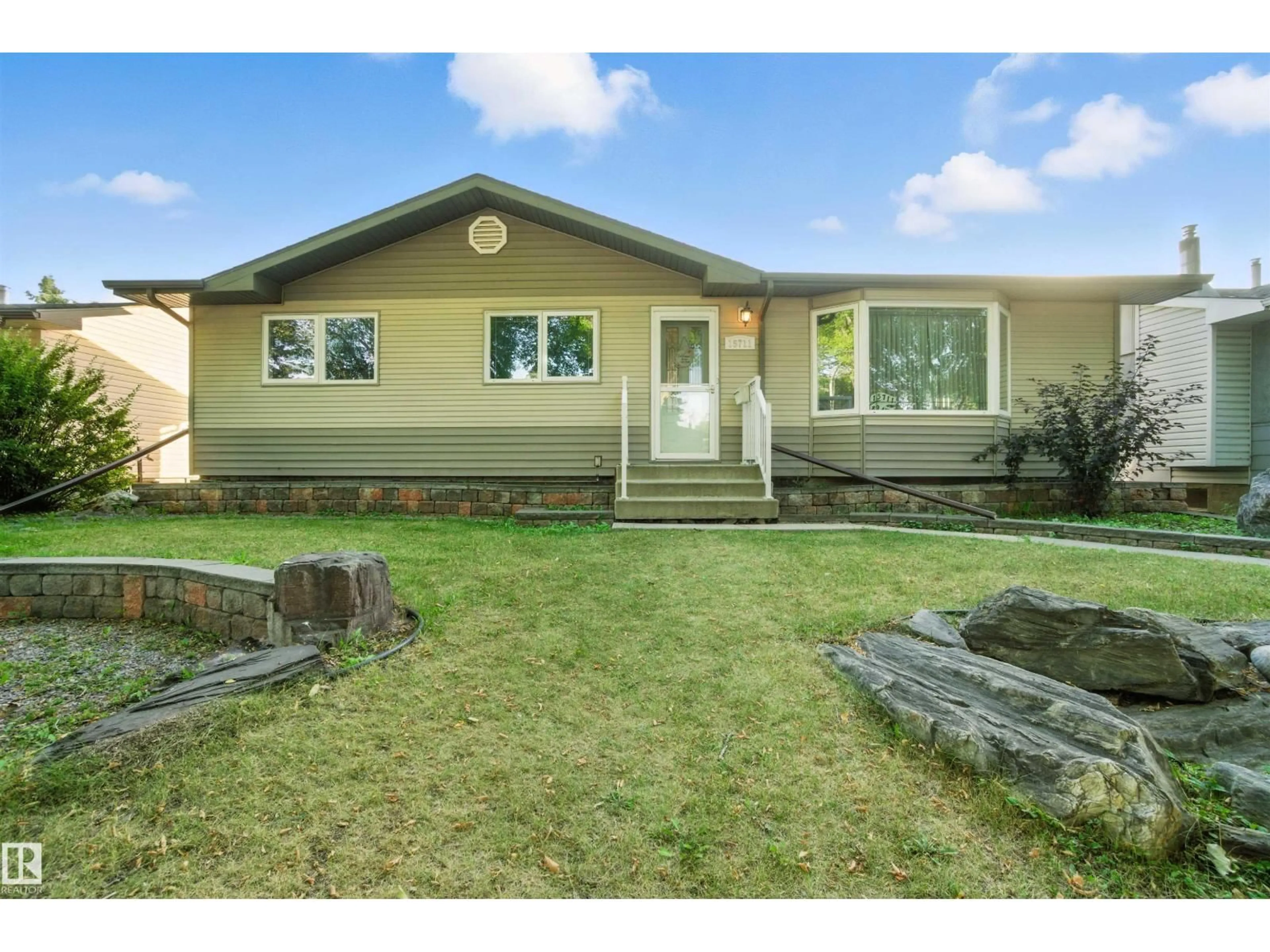 Home with vinyl exterior material, street for 15711 89 AV, Edmonton Alberta T5R4R4