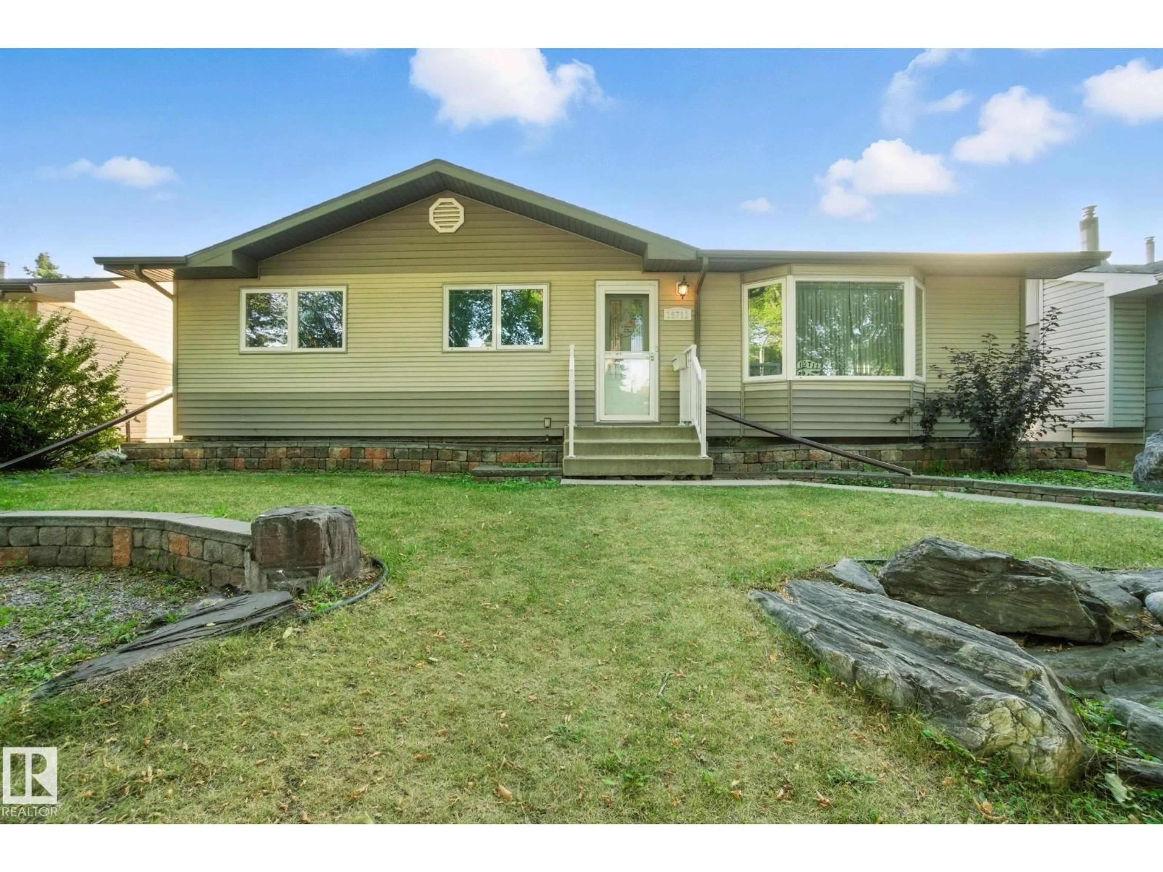Home with vinyl exterior material, street for 15711 89 AV, Edmonton Alberta T5R4R4