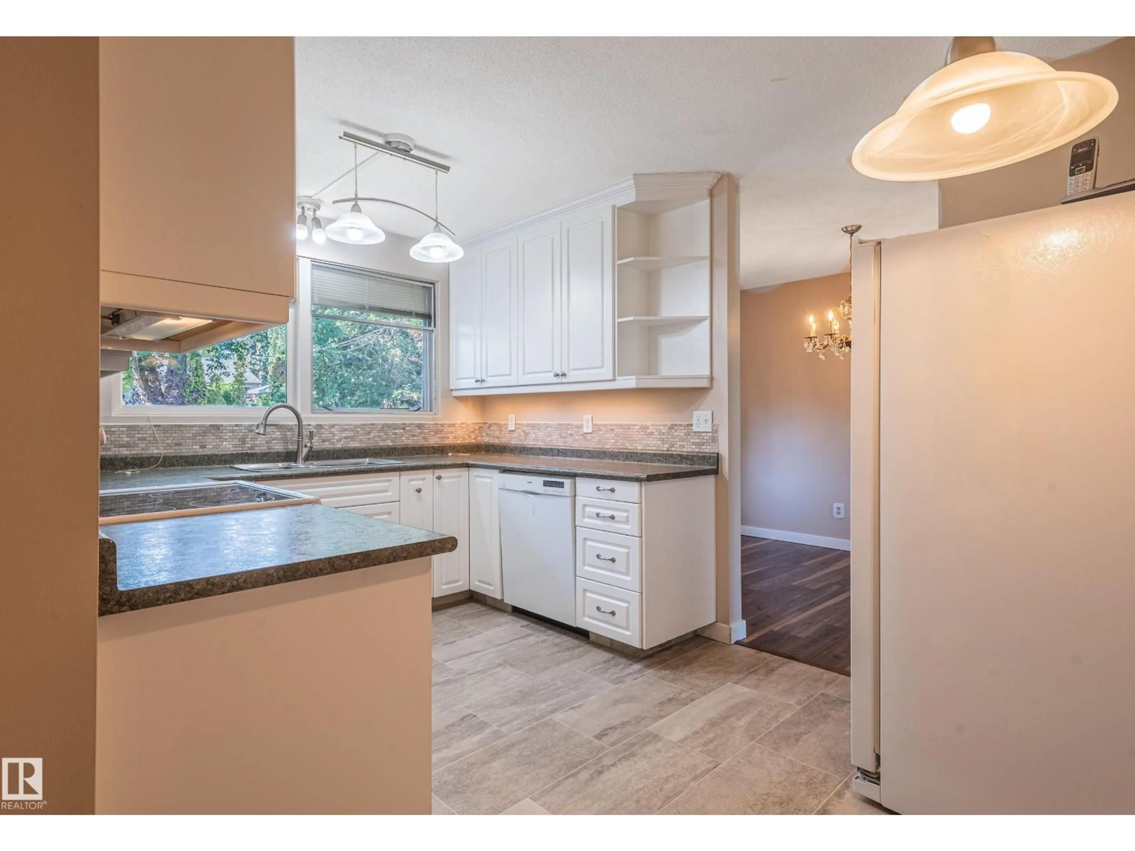 Open concept kitchen, wood/laminate floor for NW - 4212 122 ST, Edmonton Alberta T6J1Z4