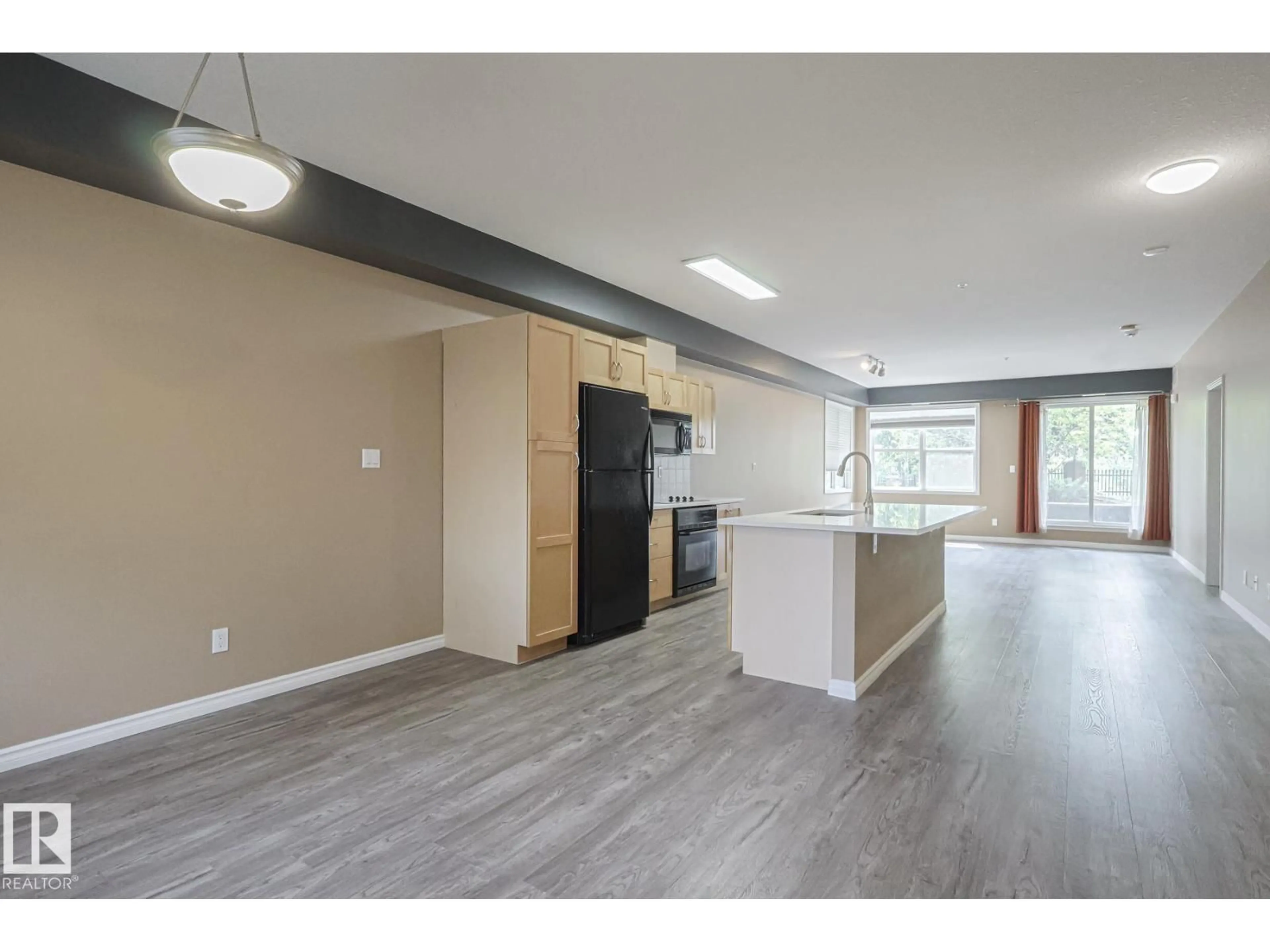 Open concept kitchen, wood/laminate floor for #113 - 9507 101 AV, Edmonton Alberta T5H4R1