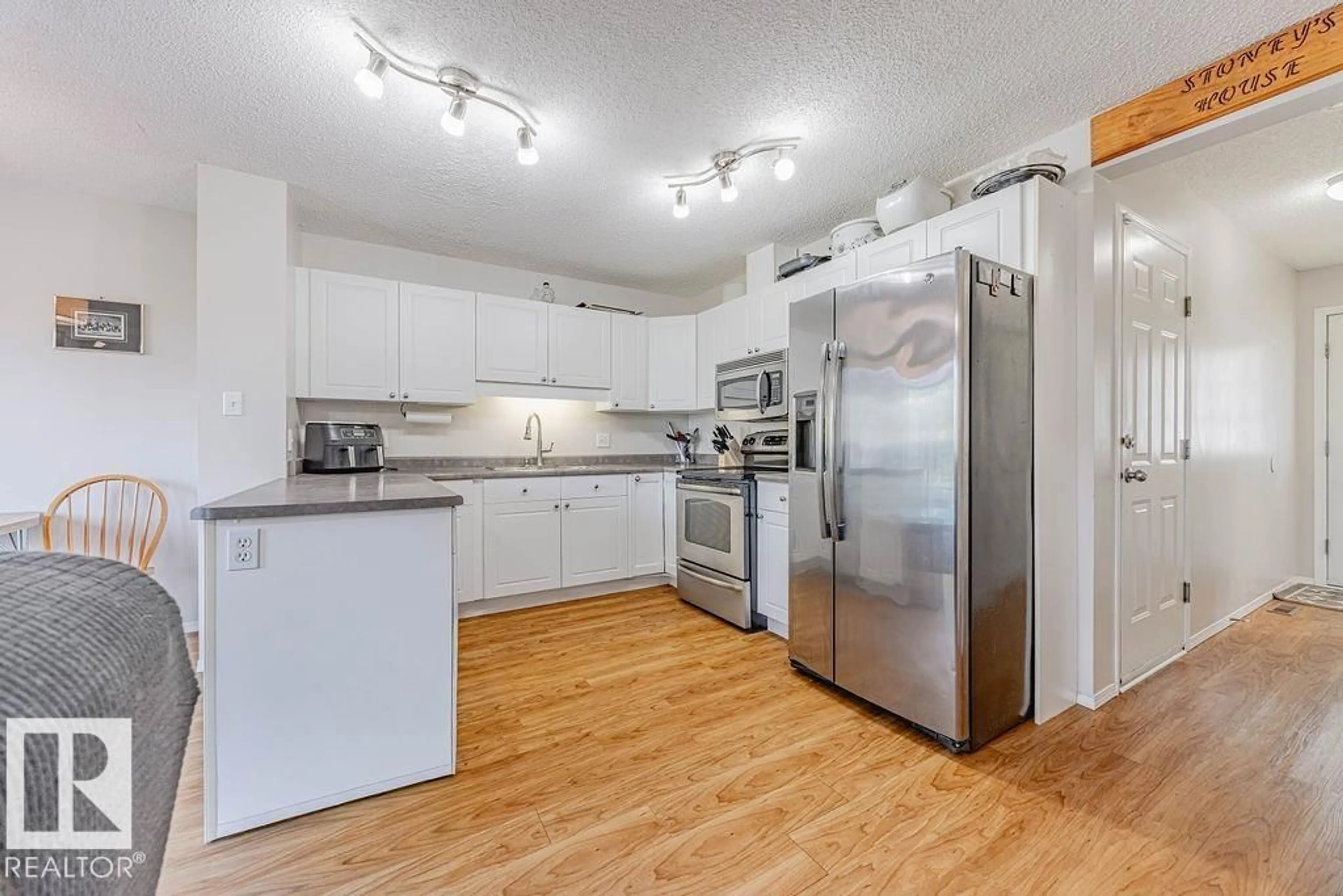 Open concept kitchen, wood/laminate floor for #7 - 2004 GRANTHAM CO, Edmonton Alberta T5T3X4