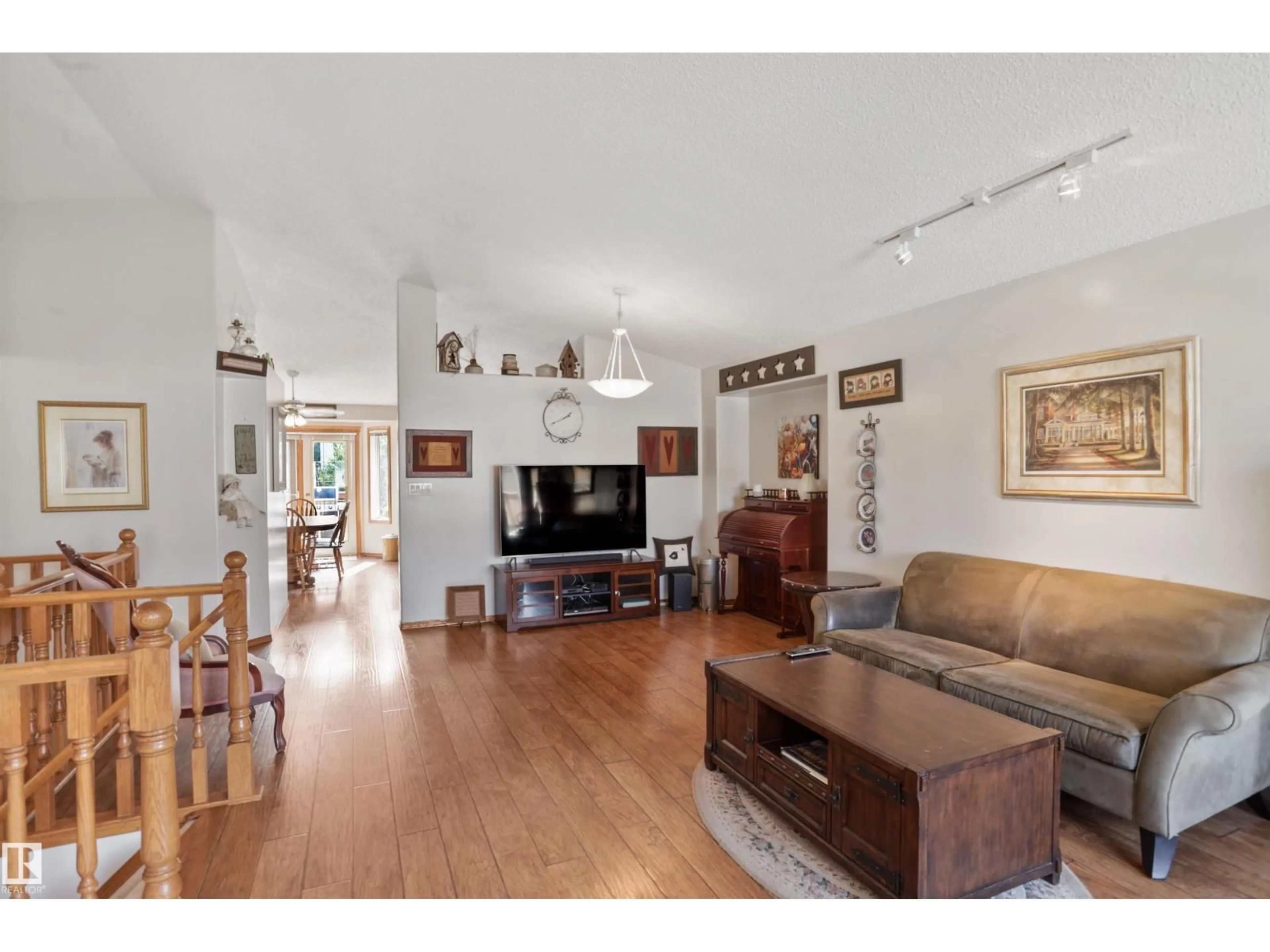 Living room with furniture, wood/laminate floor for 150 HIGHWOOD CR, Devon Alberta T9G1W6