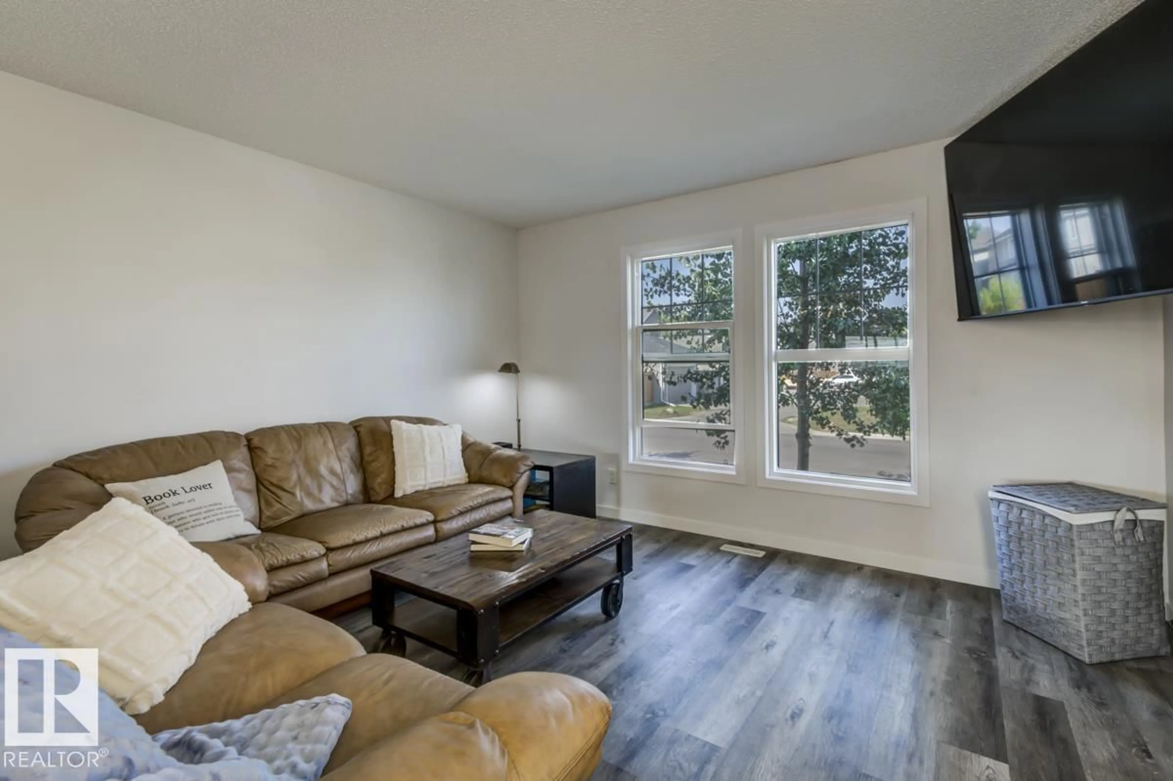 Living room with furniture, wood/laminate floor for NW - 21007 130 AV, Edmonton Alberta T5S0L4