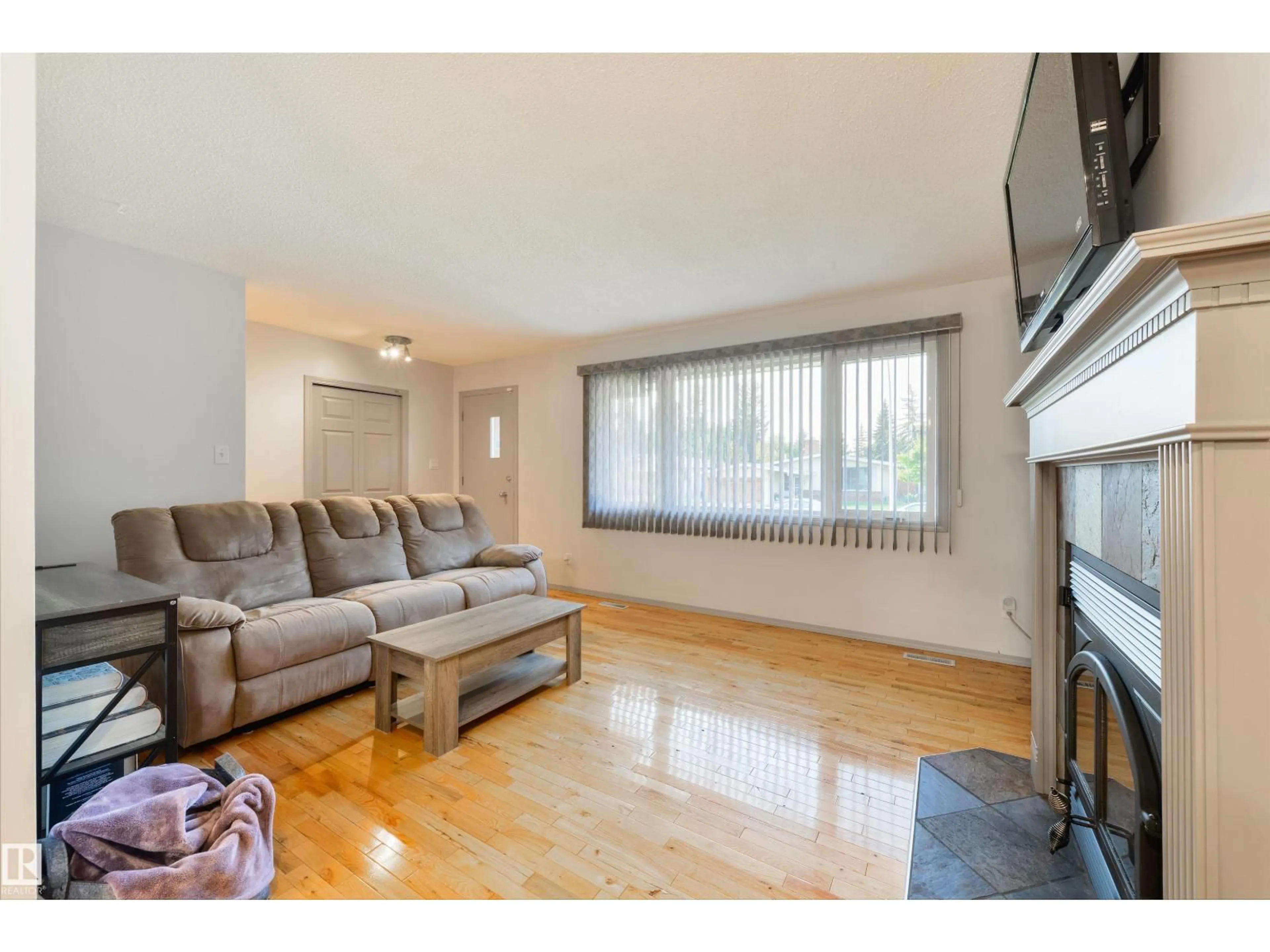 Living room with furniture, wood/laminate floor for NW - 10524 35 AV, Edmonton Alberta T6H4Z5