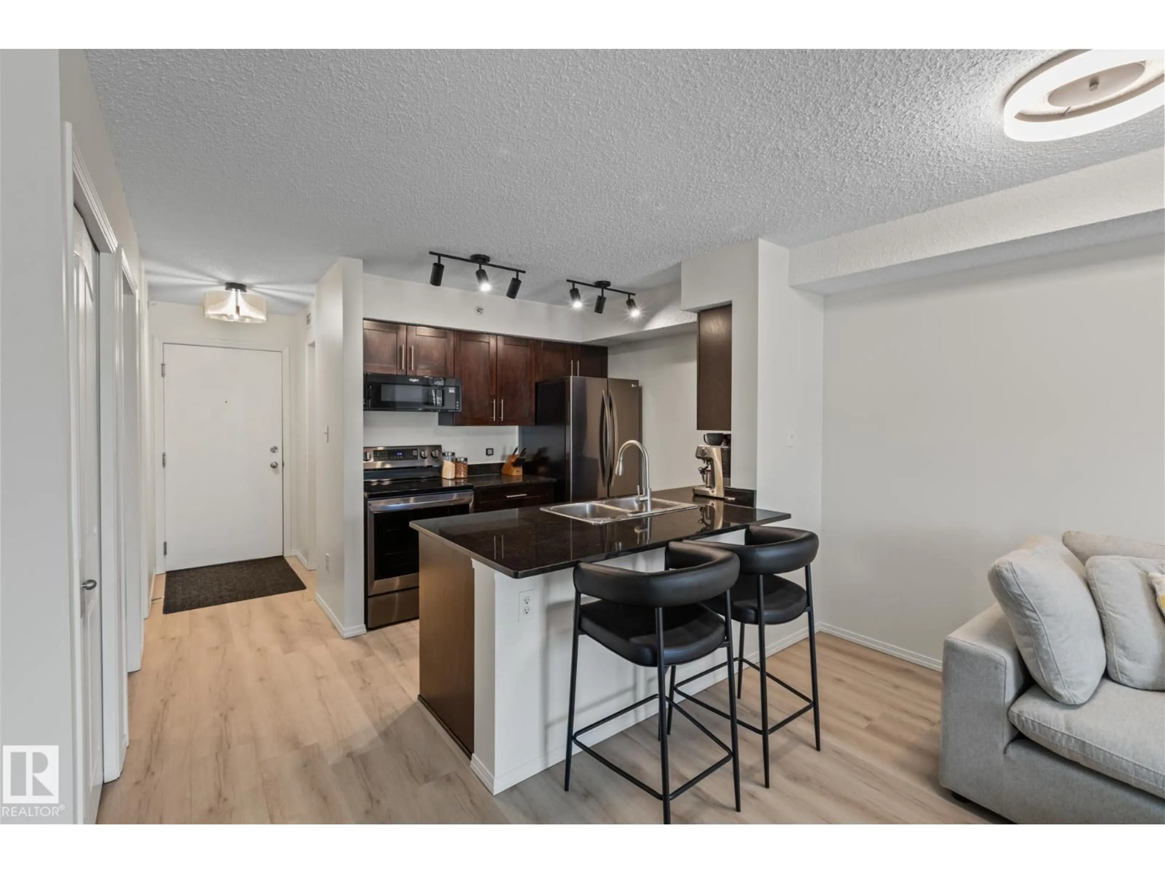 Open concept kitchen, wood/laminate floor for #409 - 1080 MCCONACHIE BLVD, Edmonton Alberta T5Y0X2