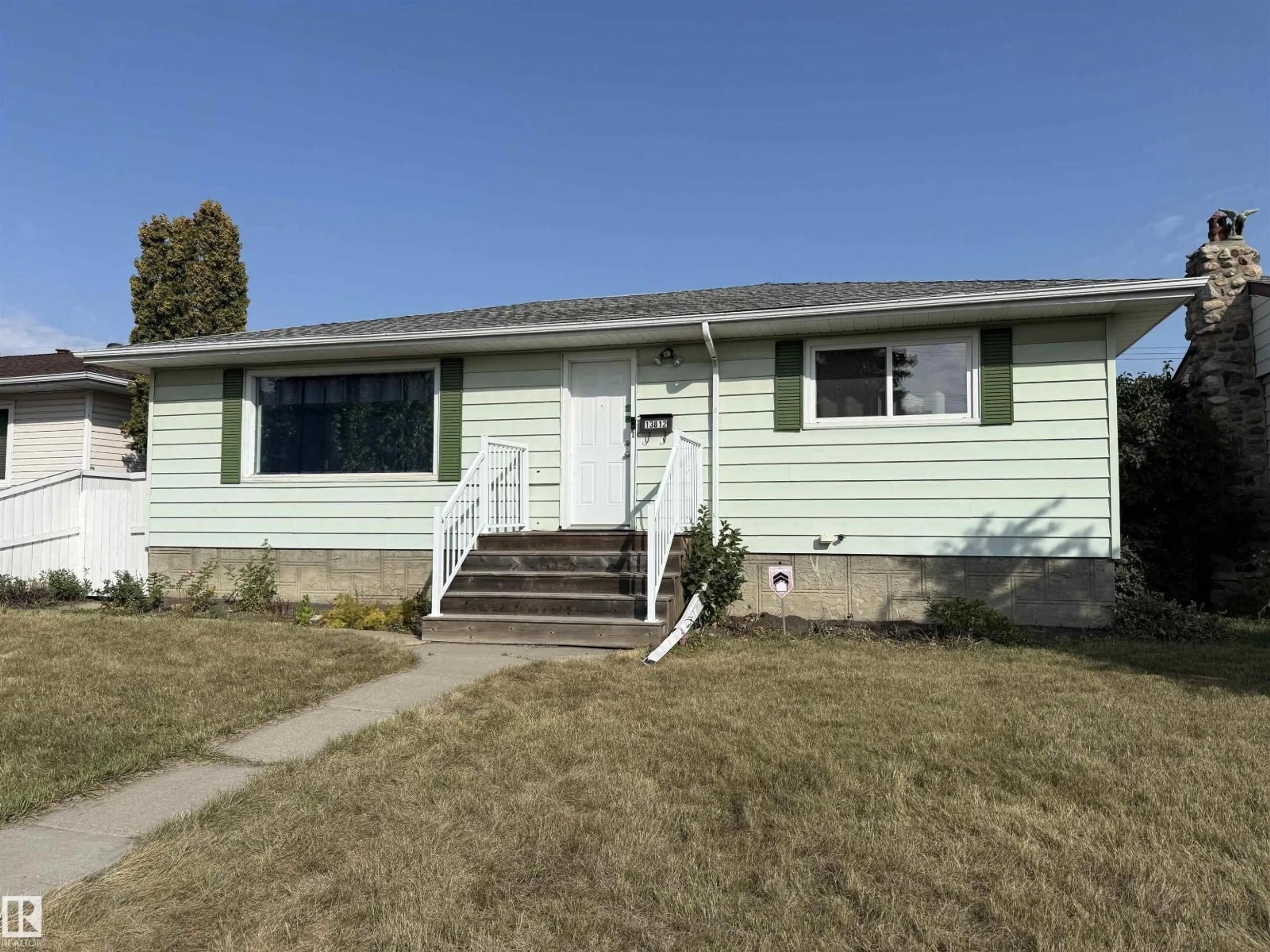 Home with vinyl exterior material, street for 13812 132 AV, Edmonton Alberta T5L3R8