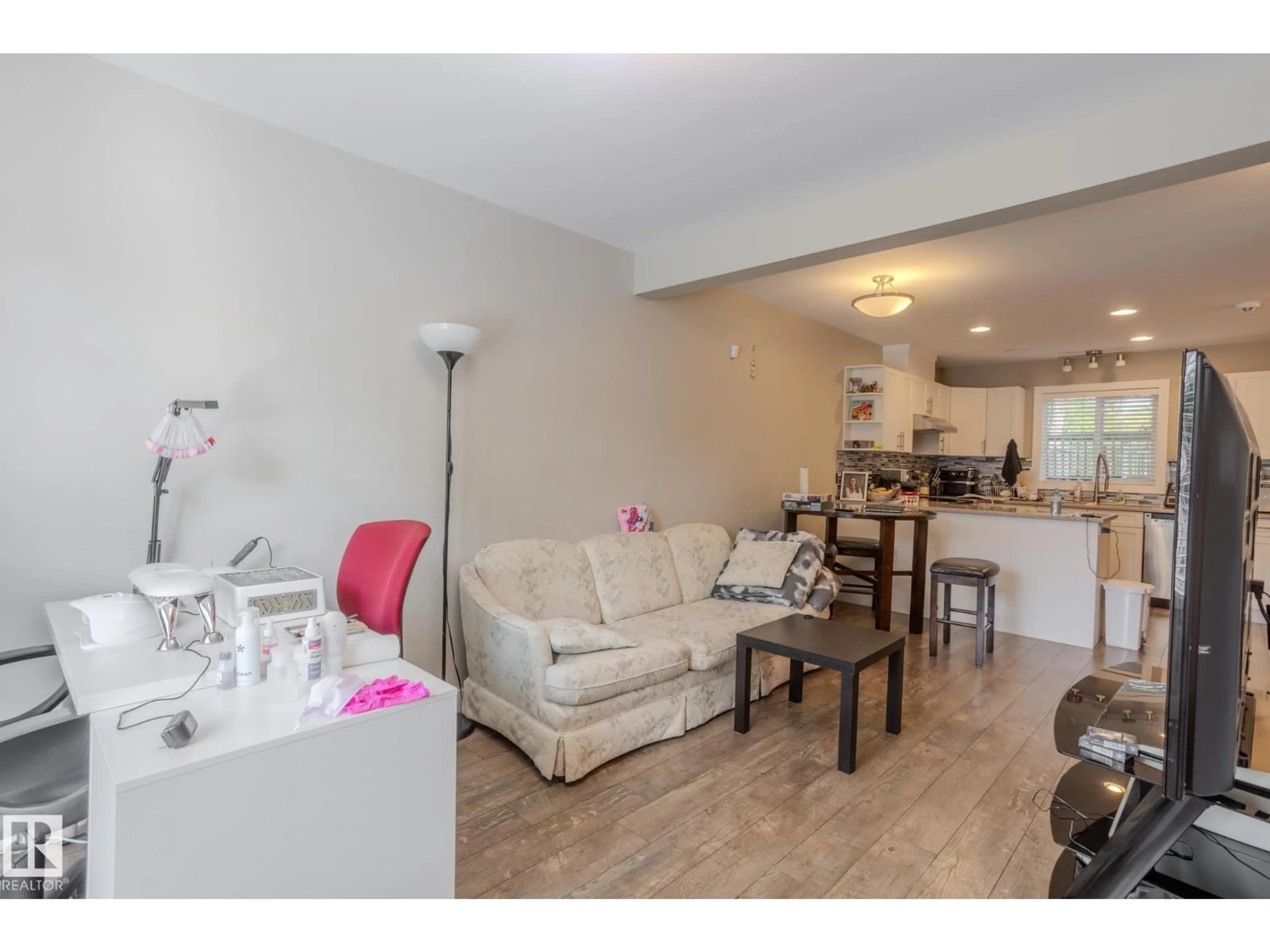 Living room with furniture, wood/laminate floor for 12504 119 AV, Edmonton Alberta T5L2Z5