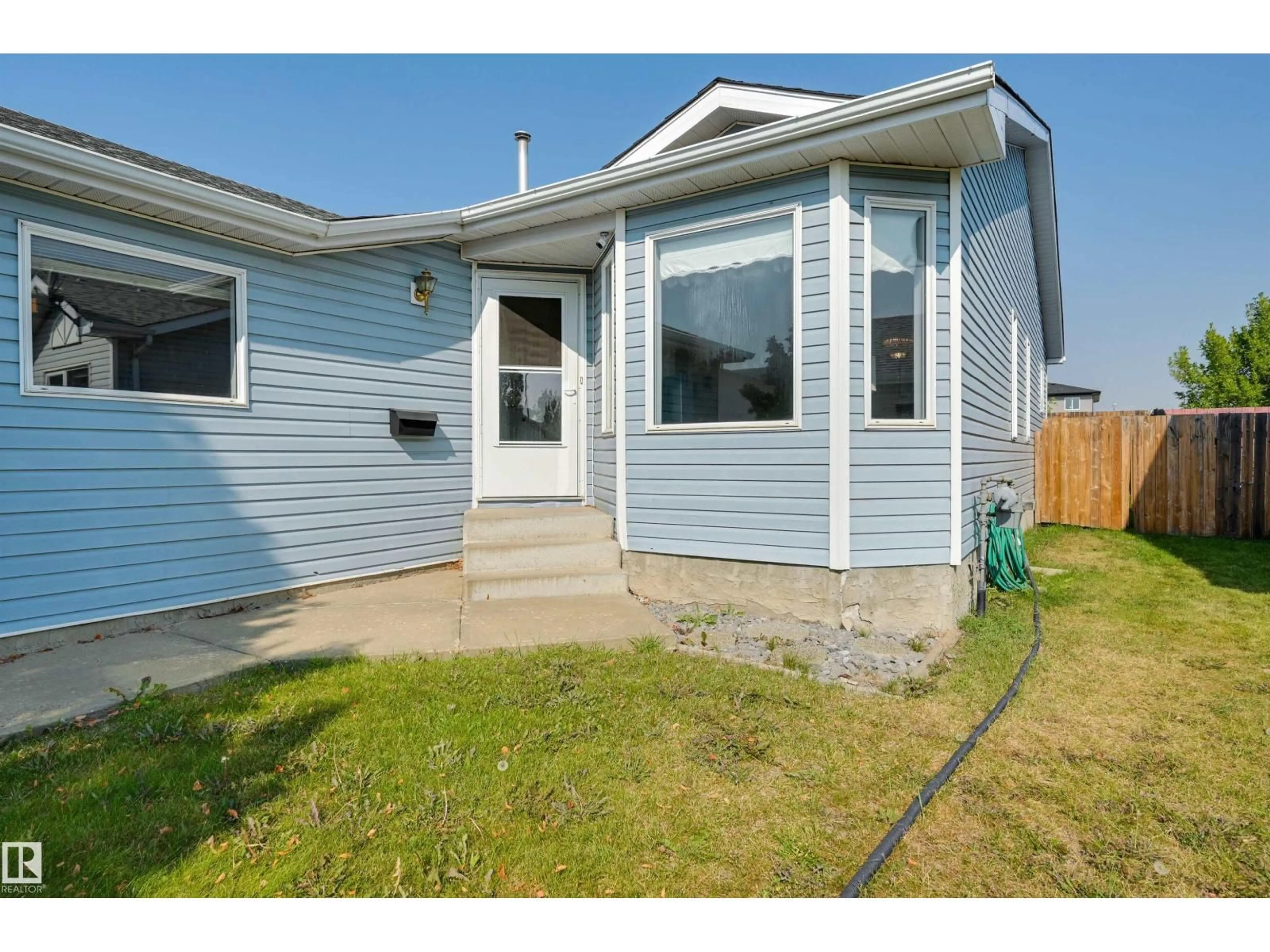 Home with vinyl exterior material, street for NW - 1928 152 AV, Edmonton Alberta T5Y2R7